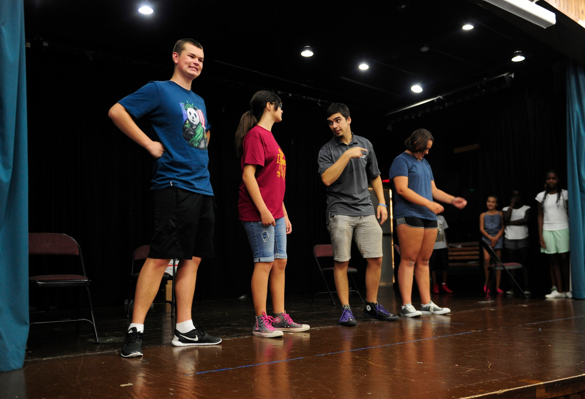 Eli Halterman, center, Missoula Children’s Theatre tour actor and director, rehearses a scene from the MCT’s musical version of Rapunzel with children from the local community Aug. 6, 2015, at Incirlik Air Base, Turkey. The MCT tours throughout every state in America and 16 different countries with the goal of developing resiliency and life skills in children through performing arts. (U.S. Air Force photo by Senior Airman Krystal Ardrey/Released)