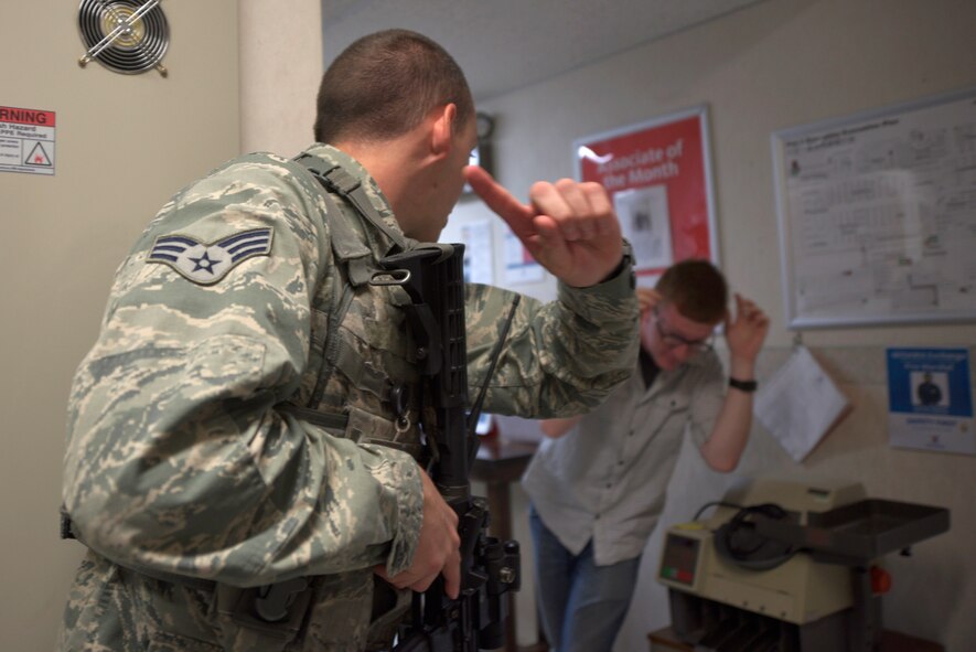 U.S. Air Force Senior Airman Scott Bost, 35th Security Forces Squadron patrolman, instructs a bystander to seek safety during an active-shooter threat exercise at Misawa Air Base, Japan, Aug. 15, 2015. As part of the training exercise, security response personnel encountered role players which added to the realism of the unpredictable environment they may face during threats like this. (U.S. Air Force photo by Senior Airman Jose L. Hernandez-Domitilo/Released)