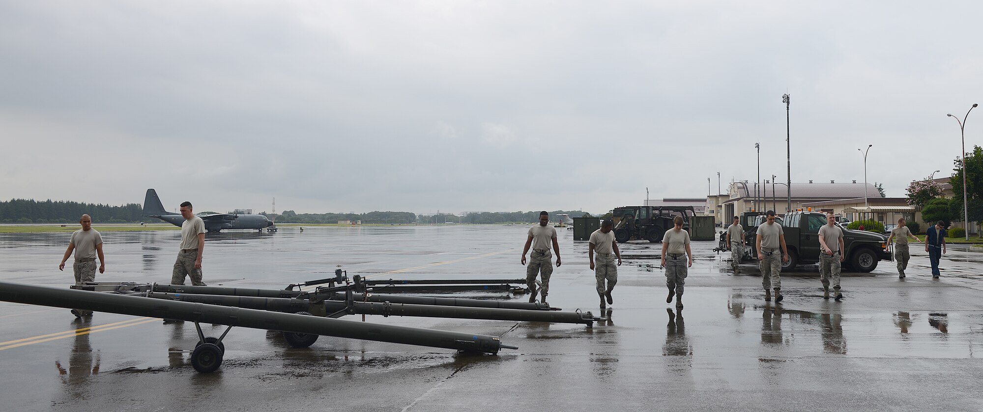 Airmen from the 374th Maintenance Squadron conduct a foreign object debris search at Yokota Air Base, Japan, Aug. 12, 2015. FOD walks are performed daily to ensure the safety of Yokota’s Airmen and equipment. (U.S. Air Force photo by Senior Airman David C. Danford/Released)