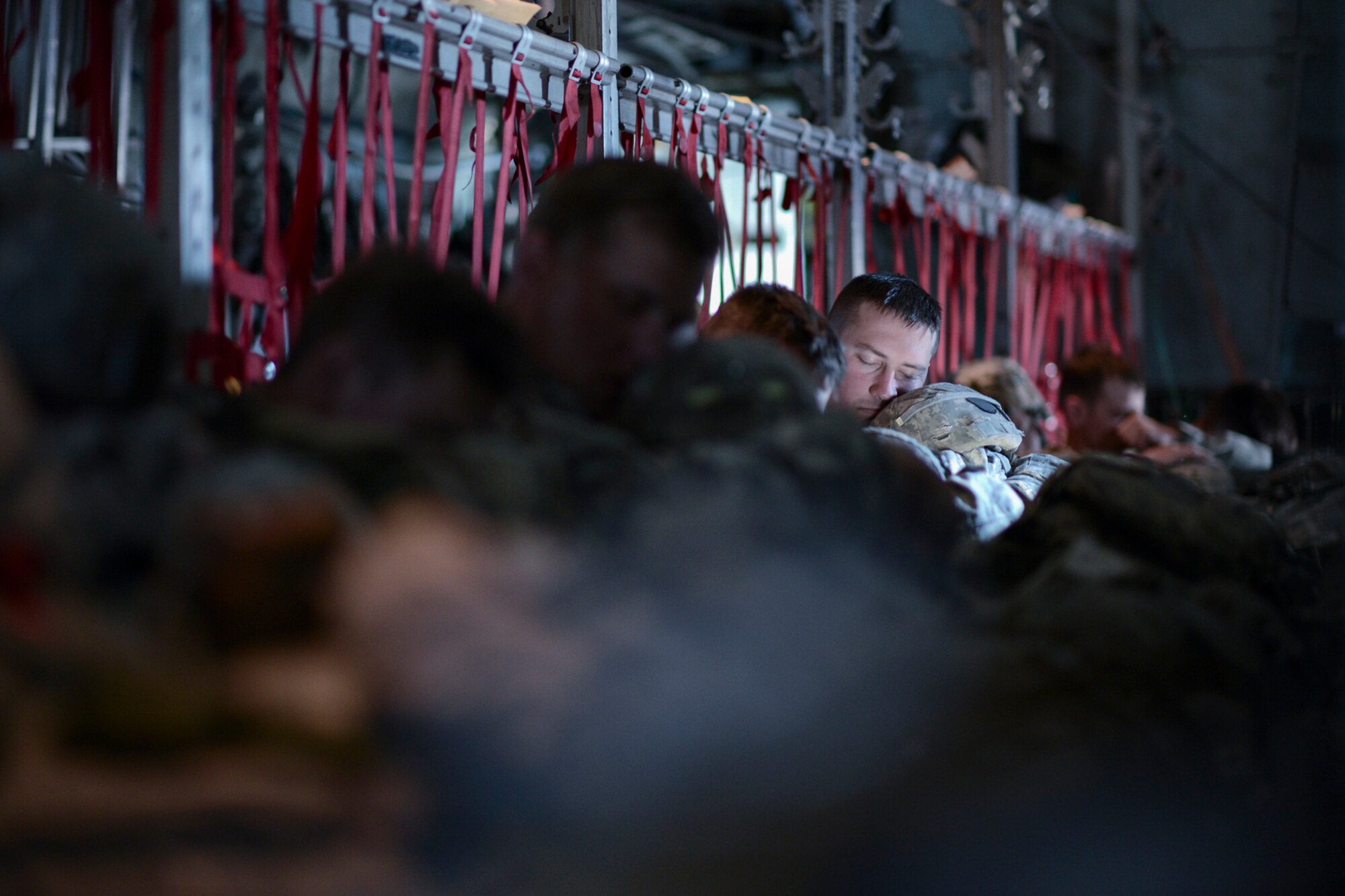 A U.S. Army Soldier with the 1st Battalion (Airborne), 501st Infantry Regiment, falls asleep while waiting to jump from a C-130 Hercules from Yokota Air Base, Japan, during Red Flag-Alaska at Joint Base Elmendorf-Richardson, Alaska, Aug. 12, 2015. More than 60 U.S. Army Soldiers with the 1-501 Parachute Infantry Regiment and more than 20 Japan Ground Self-Defense Force members jumped from multiple C-130 Hercules during the training. More than 20 allied countries have participated in RED FLAG-Alaska since its conception, improving integration, interoperability and cross-cultural competence. (U.S. Air Force photo by Staff Sgt. Cody H. Ramirez/Released)