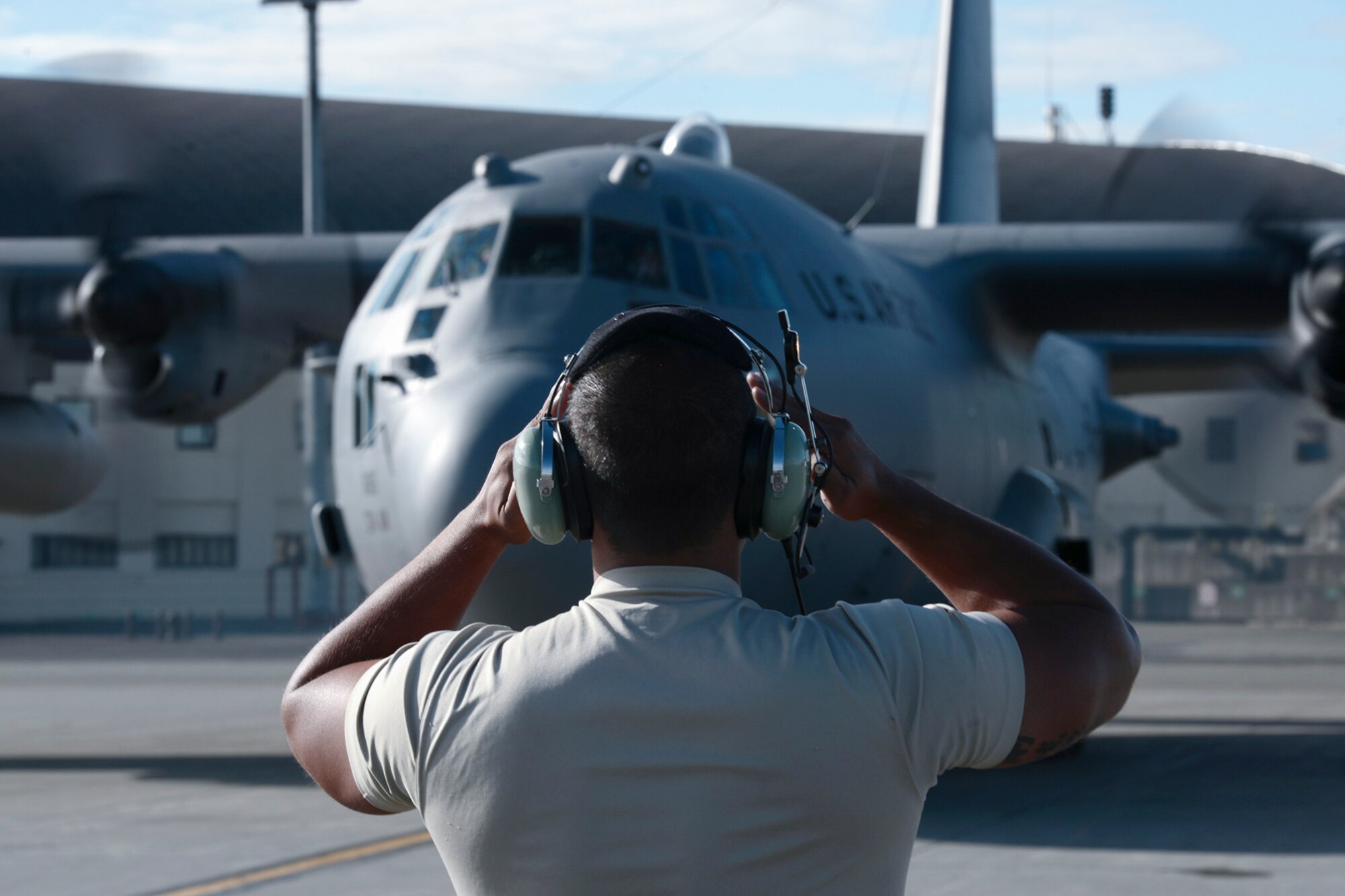 A maintainer with the 374th Aircraft Maintenance Squadron marshals a C-130 Hercules from Yokota Air Base, Japan, during Red Flag-Alaska at Joint Base Elmendorf-Richardson, Alaska, Aug. 11, 2015. Red Flag-Alaska is an exercise that provides joint offensive counter-air, interdiction, close air support and large force employment training in a simulated combat environment. More than 20 allied countries have participated in Red Flag-Alaska since its conception, improving integration, interoperability and cross-cultural competence. (U.S. Air Force photo by Staff Sgt. Cody H. Ramirez/Released)