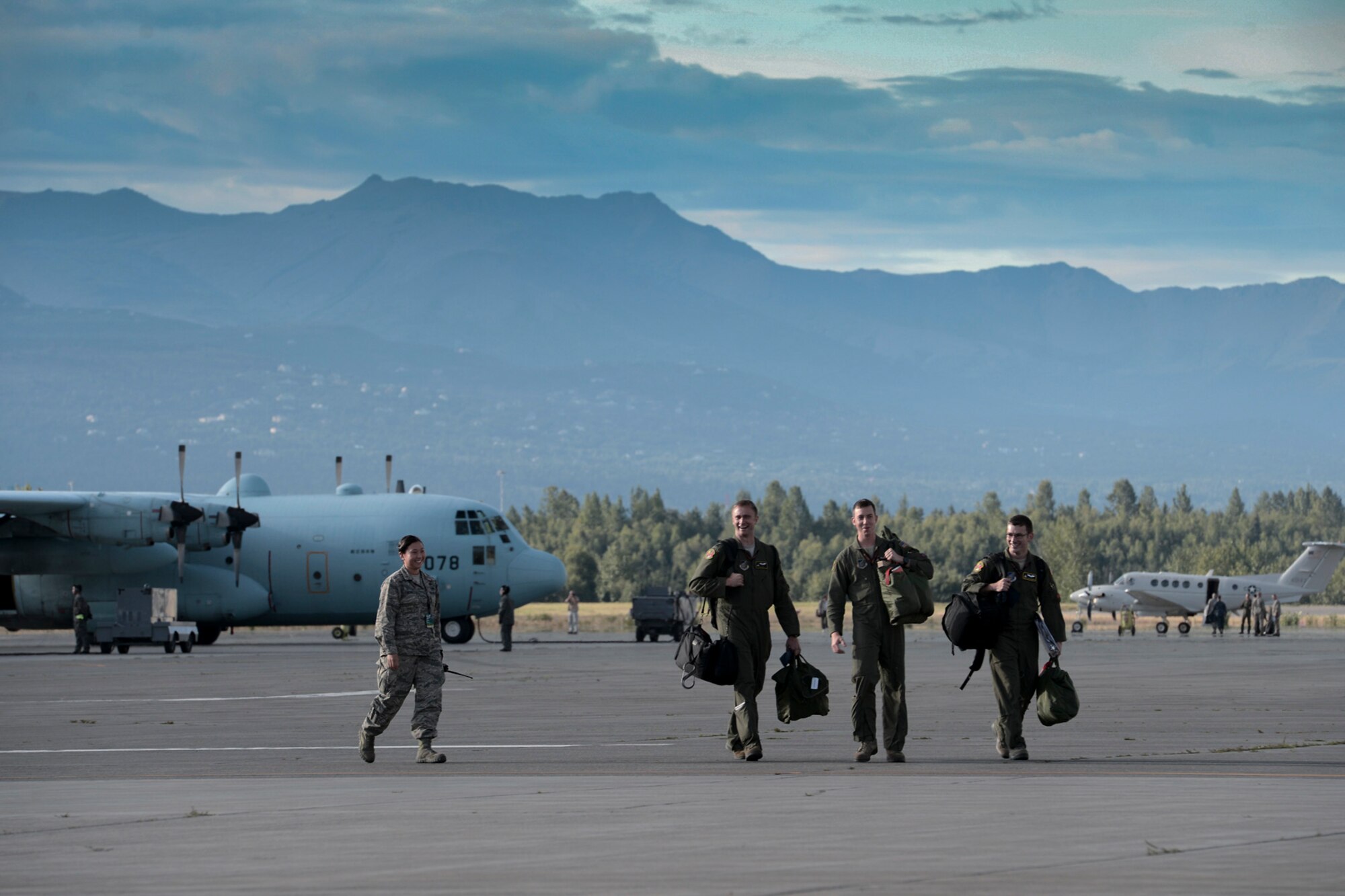 Aircrew walk to a C-130 Hercules from Yokota Air Base, Japan, during Red Flag-Alaska at Joint Base Elmendorf-Richardson, Alaska, Aug. 11, 2015. Red Flag-Alaska is an exercise that provides joint offensive counter-air, interdiction, close air support and large force employment training in a simulated combat environment. More than 20 allied countries have participated in Red Flag-Alaska since its conception, improving integration, interoperability and cross-cultural competence. (U.S. Air Force photo by Staff Sgt. Cody H. Ramirez/Released)