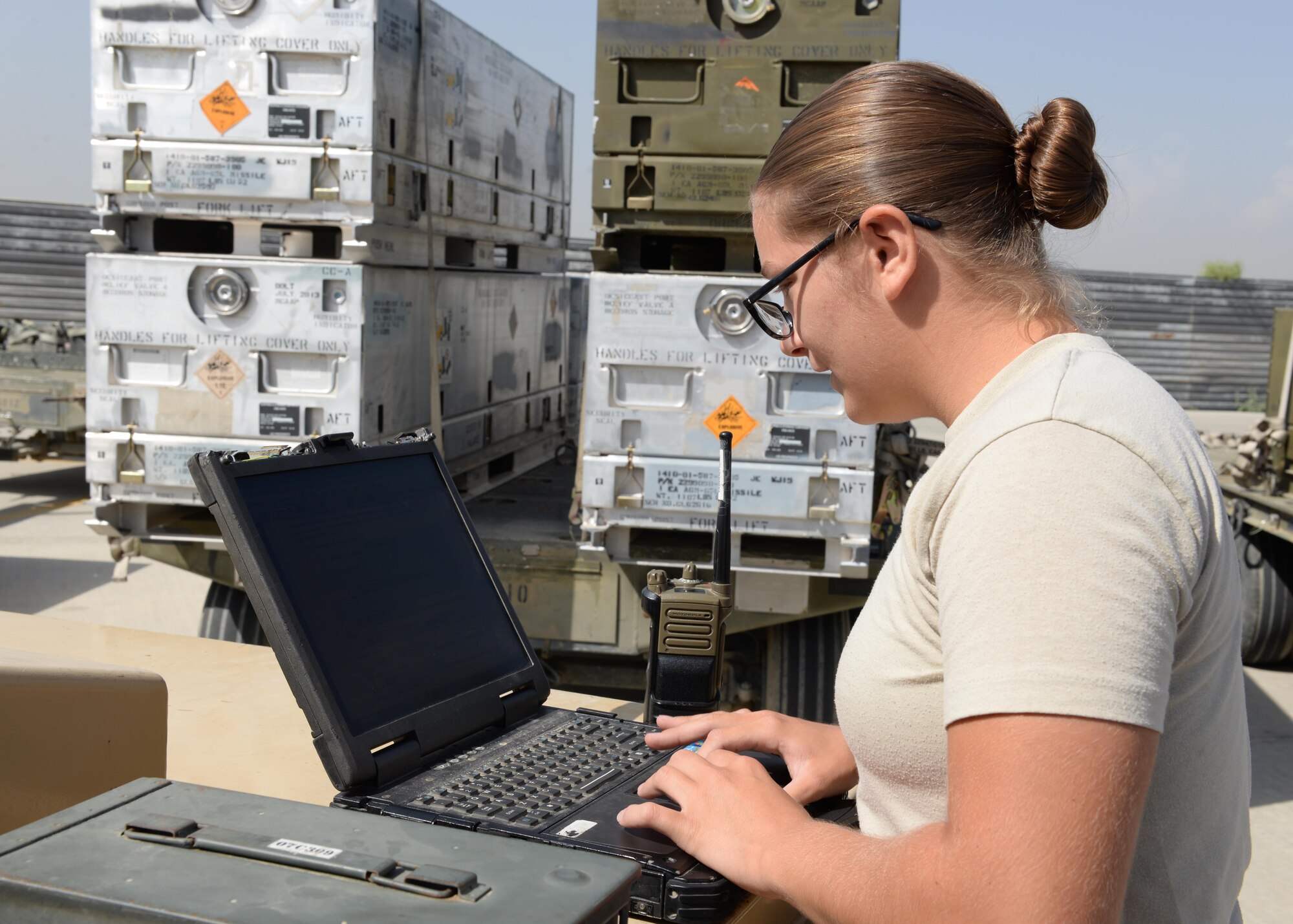 U.S. Air Force Airman First Class Morgan Strausser, 455th Expeditionary Maintenance Squadron line delivery crew chief, looks over safety instructions before loading munitions onto a truck Aug. 12, 2015, at Bagram Airfield, Afghanistan. Strausser is responsible for loading and unloading ammo from the F-16 Fighting Falcon aircraft here. (U.S. Air Force photo by Senior Airman Cierra Presentado/Released)