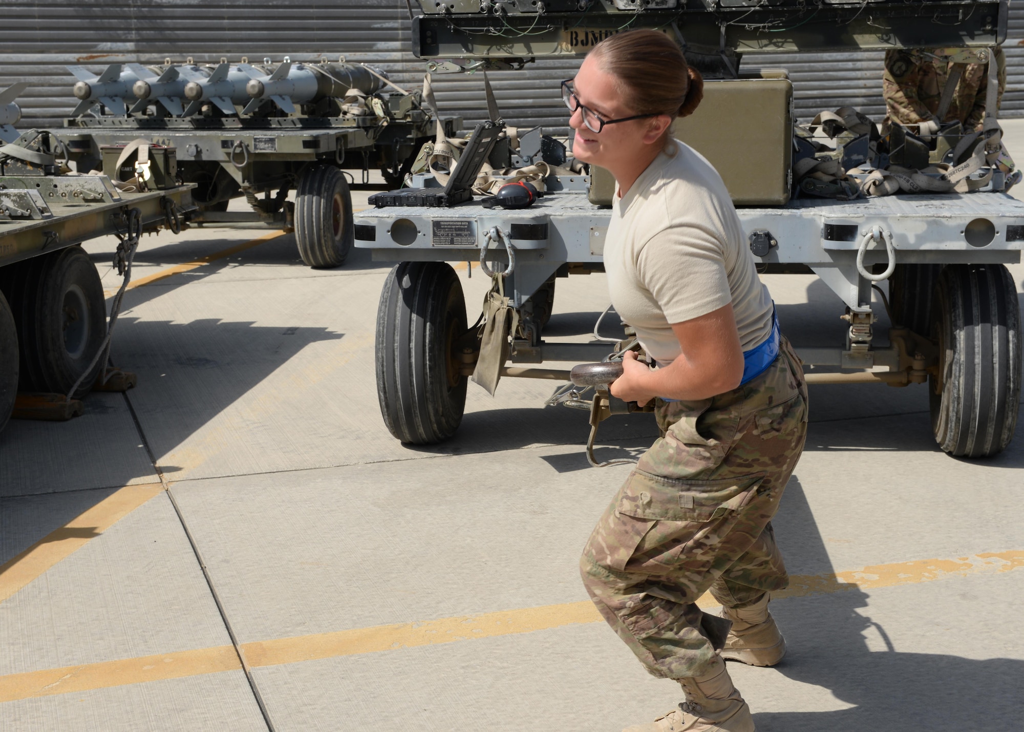 U.S. Air Force Airman First Class Morgan Strausser, 455th Expeditionary Maintenance Squadron line delivery crew chief, pulls a trailer loaded with munitions Aug. 12, 2015, at Bagram Airfield, Afghanistan. Strausser is responsible for loading and unloading ammo from the F-16 Fighting Falcon aircraft here. (U.S. Air Force photo by Senior Airman Cierra Presentado/Released)