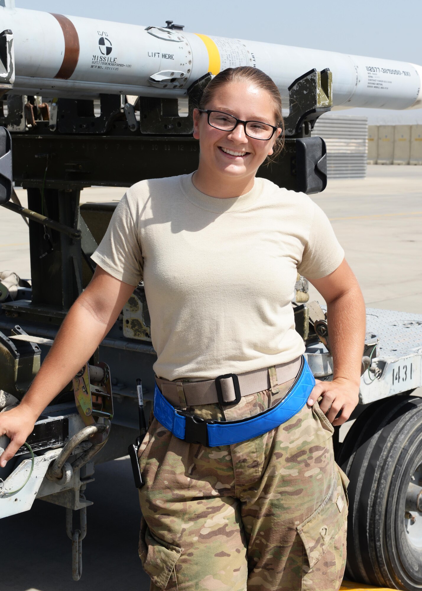 U.S. Air Force Airman First Class Morgan Strausser, 455th Expeditionary Maintenance Squadron line delivery crew chief, poses for a photo Aug. 12, 2015, at Bagram Airfield, Afghanistan. Strausser is responsible for loading and unloading ammo from the F-16 Fighting Falcon aircraft here. (U.S. Air Force photo by Senior Airman Cierra Presentado/Released)