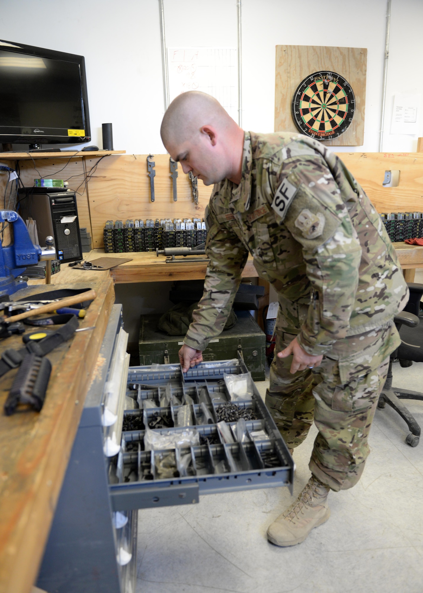 U.S. Air Force TSgt. Kevin Beers, 455th Expeditionary Security Forces Squadron combat arms instructor, looks for weapons parts for an M-4 rifle Aug. 10, 2015, at Bagram Airfield, Afghanistan. As Bagram’s only weapons repairman, Beers is responsible for repairing weapons for the security forces squadron, logistics readiness squadron, Marines and all other units here. (U.S. Air Force photo by Senior Airman Cierra Presentado/Released)