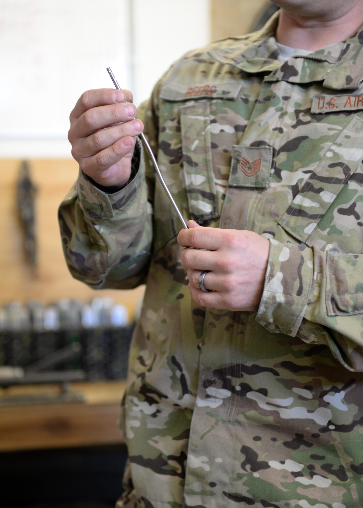 U.S. Air Force TSgt. Kevin Beers, 455th Expeditionary Security Forces Squadron combat arms instructor, looks at a weapons part Aug. 10, 2015, at Bagram Airfield, Afghanistan. As Bagram’s only weapons repairman, Beers is responsible for repairing weapons for the security forces squadron, logistics readiness squadron, Marines and all other units here. (U.S. Air Force photo by Senior Airman Cierra Presentado/Released)