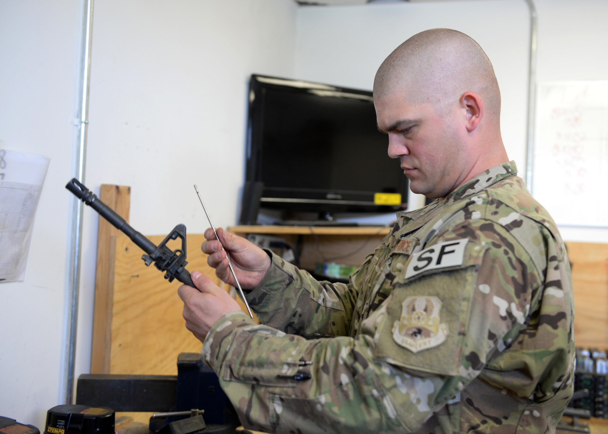 U.S. Air Force TSgt. Kevin Beers, 455th Expeditionary Security Forces Squadron combat arms instructor, repairs an M-4 rifle part Aug. 10, 2015, at Bagram Airfield, Afghanistan. As Bagram’s only weapons repairman, Beers is responsible for repairing weapons for the security forces squadron, logistics readiness squadron, Marines and all other units here. (U.S. Air Force photo by Senior Airman Cierra Presentado/Released)