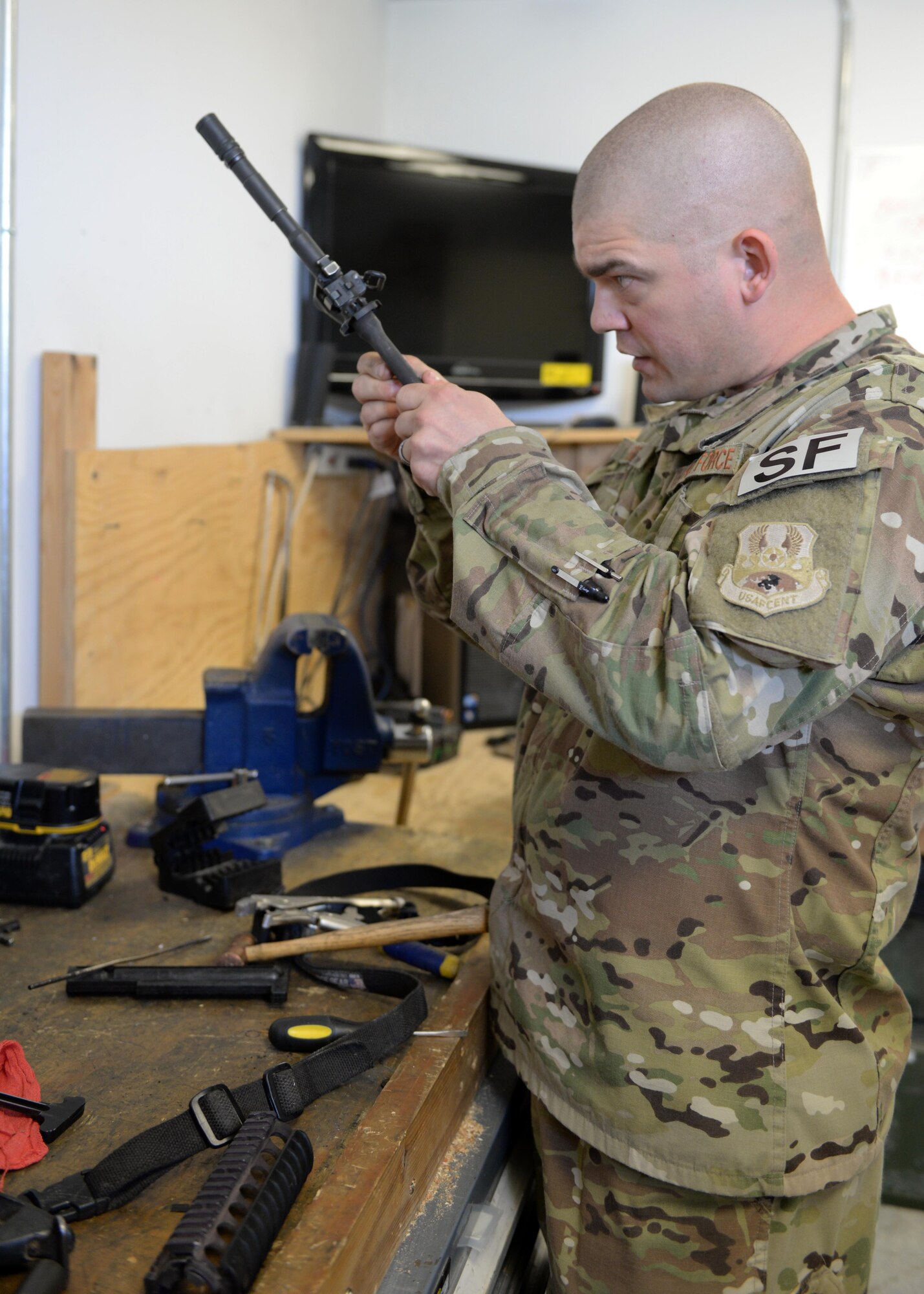 U.S. Air Force TSgt. Kevin Beers, 455th Expeditionary Security Forces Squadron combat arms instructor, repairs an M-4 rifle part Aug. 10, 2015, at Bagram Airfield, Afghanistan. As Bagram’s only weapons repairman, Beers is responsible for repairing weapons for the security forces squadron, logistics readiness squadron, Marines and all other units here. (U.S. Air Force photo by Senior Airman Cierra Presentado/Released)
