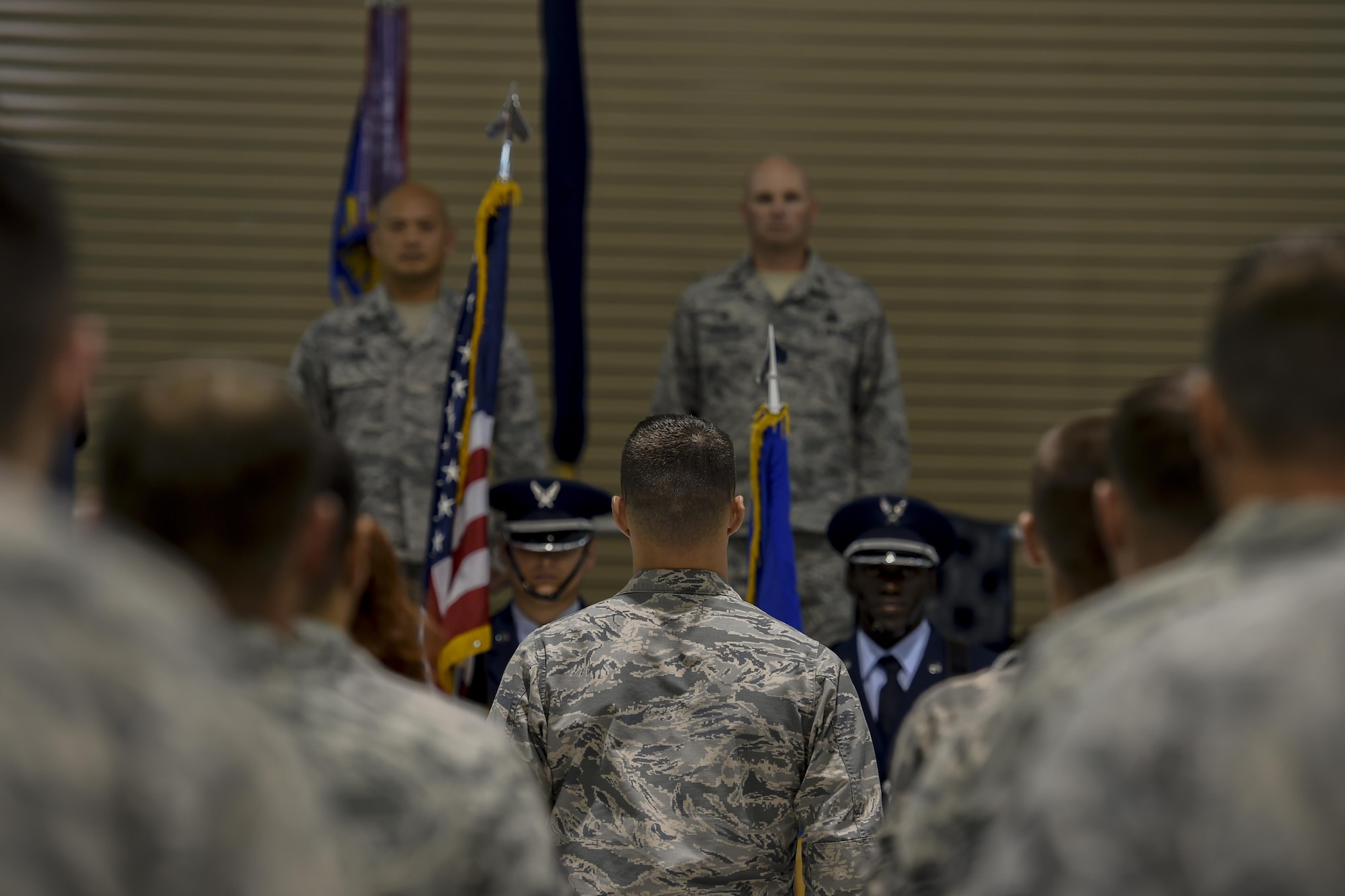 1st Special Operations Maintenance Squadron Airmen stand at attention during the presentation of colors at the 1st SOMXS activation ceremony, Aug. 10, 2015, at Hurlburt Field, Fla. During the ceremony, the 1st Special Operations Component Maintenance Squadron and the 1st Special Operations Equipment Maintenance Squadron deactivated and formed the newly activated 1st SOMXS. (U.S. Air Force photo by Airman 1st Class Ryan Conroy/Released)