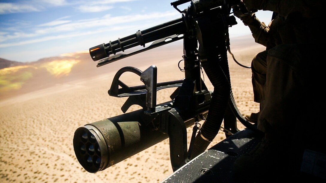 The M134 mini-gun fires hundreds of 7.62 mm rounds out of the side of the UH-1Y helicopter during a close air support and escort training exercise in preparation for Large Scale Exercise 15 aboard Marine Corps Air Ground Combat Training Center Twentynine Palms, Calif., Aug. 11, 2015. LSE-15 is a combined U.S. Marine Corps, Canadian and British exercise conducted at the Brigade-level, designed to enable live, virtual and constructive training for participating forces.