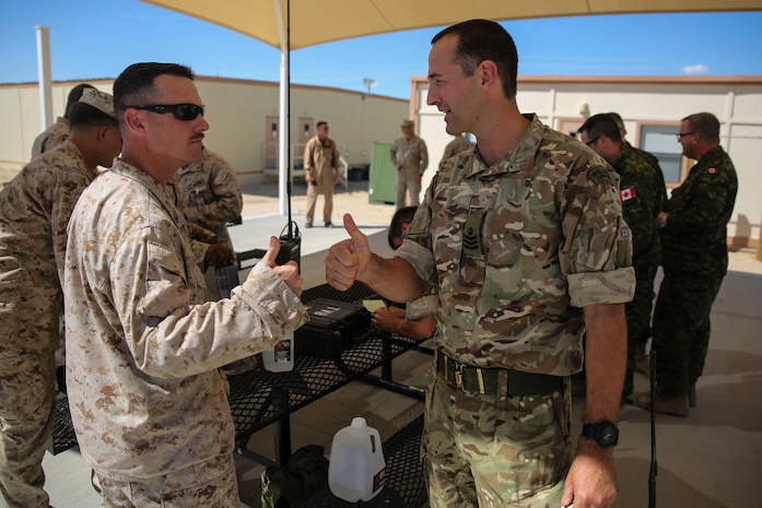 A Marine with 2nd Marine Expeditionary Brigade returns a thumb up to a British soldier after completing an interoperability communication test at Camp Wilson, Twentynine Palms, Calif., in support of the 2nd MEB Large Scale Exercise Aug. 7, 2015. LSE is a combined U.S. Marine Corps, Canadian, and British exercise conducted at the Brigade-level, designed to enable live, virtual and constructive training for participating forces.
