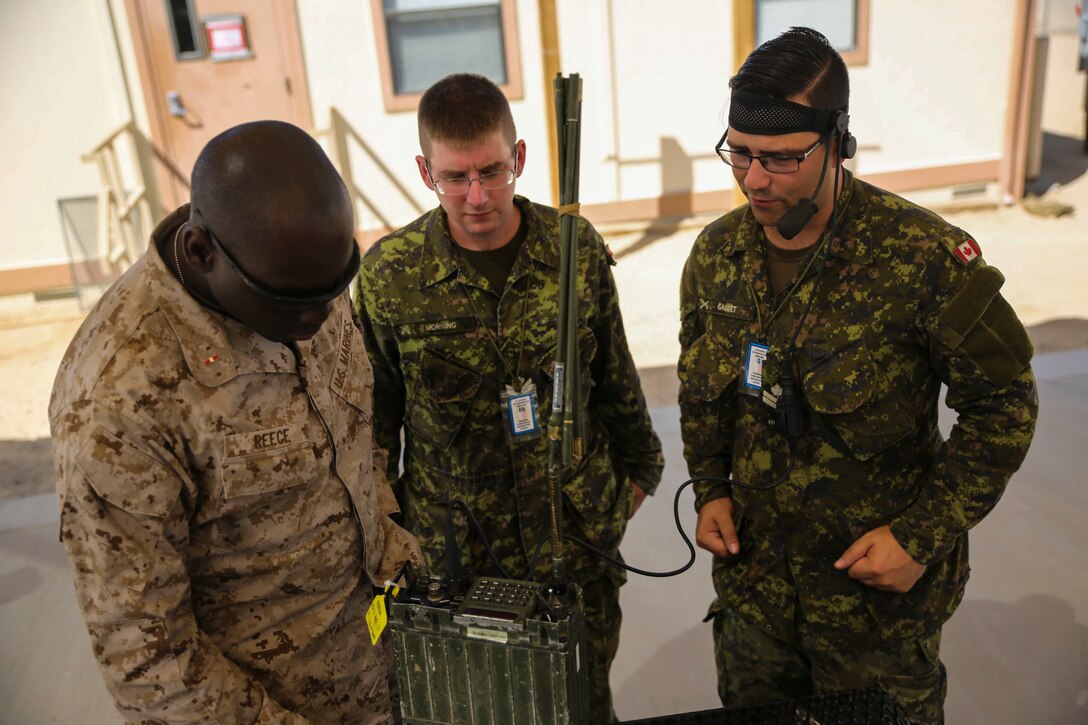 Servicemembers with 2nd Marine Expeditionary Brigade perform an interoperability communication test with their Canadian and British counterparts at Camp Wilson, Twentynine Palms, Calif., in support of the 2nd MEB Large Scale Exercise Aug. 7, 2015. LSE is a combined U.S. Marine Corps, Canadian, and British exercise conducted at the Brigade-level, designed to enable live, virtual and constructive training for participating forces.