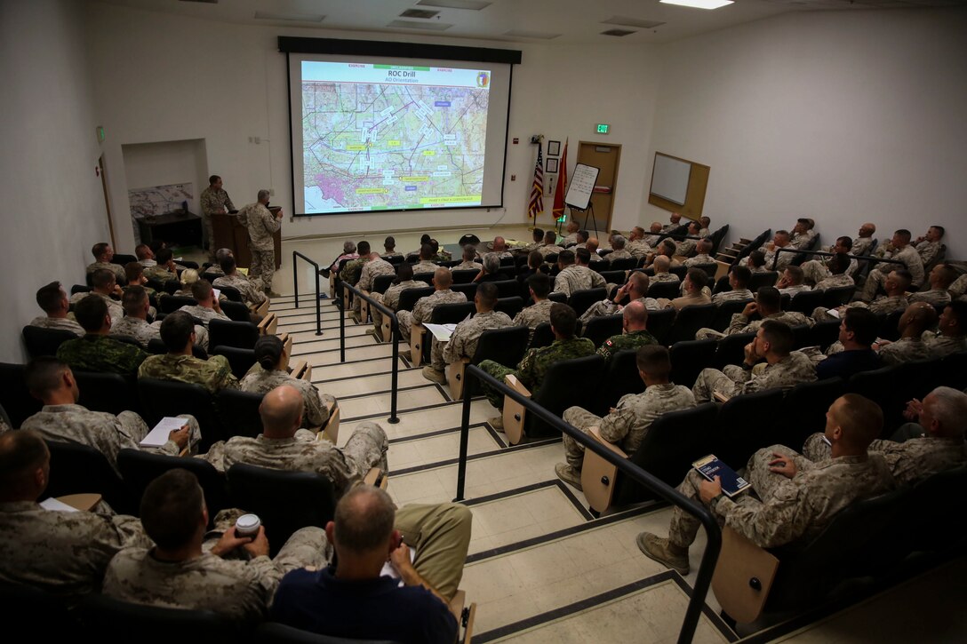 Marines with 2nd Marine Expeditionary Brigade participate in a rehearsal of concept drill along with their British and Canadian counterparts at the Tactical Training Exercise Control Group auditorium aboard Marine Corps Air Ground Combat Center Twentynine Palms, Calif., in support of the 2nd MEB Large Scale Exercise Aug. 7, 2015. LSE is a combined U.S. Marine Corps, Canadian, and British exercise conducted at the Brigade-level, designed to enable live, virtual and constructive training for participating forces.