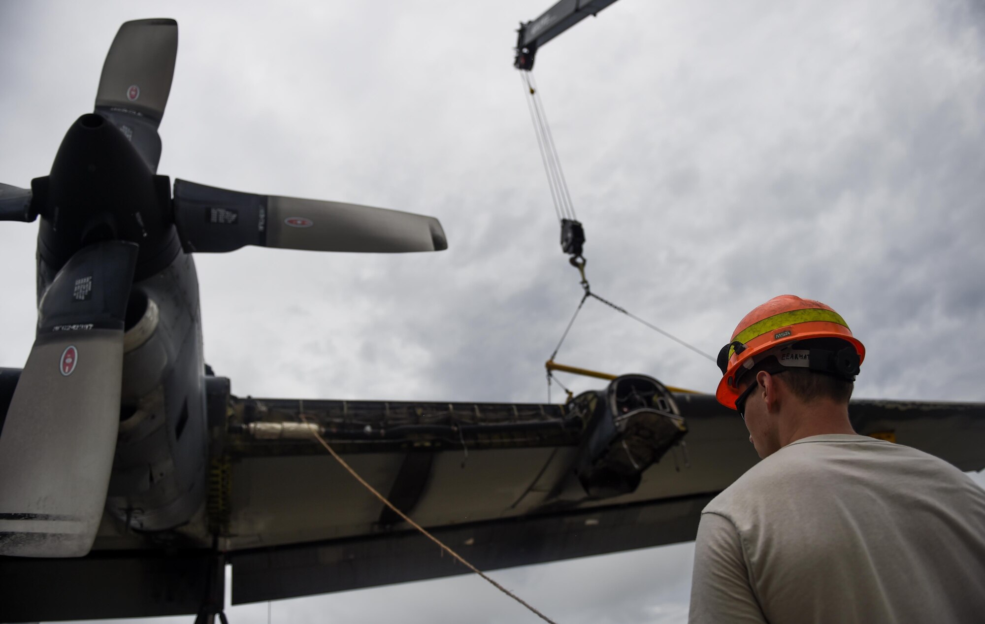 An Airman with the 402nd Expeditionary Maintenance team, Robins Air Force Base, Ga., guides the removal of an MC-130P Combat Shadow wing at Hurlburt Field, Fla., Aug. 5, 2015. The MC-130P Combat Shadow, “Team Shadow,” and an AC-130H Specter, “Wicked Wanda,” were towed to the Hurlburt Field Air Park Aug. 15, 2015.  (U.S. Air Force photo by Airman Kai White/Released)