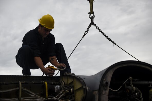 An Airman with the 402nd Expeditionary Maintenance team, Robins Air Force Base, Ga., guides the removal of an MC-130P Combat Shadow wing at Hurlburt Field, Fla., Aug. 5, 2015. The MC-130P Combat Shadow, “Team Shadow,” and an AC-130H Specter, “Wicked Wanda,” were towed to the Hurlburt Field Air Park Aug. 15, 2015.  (U.S. Air Force photo by Airman Kai White/Released)