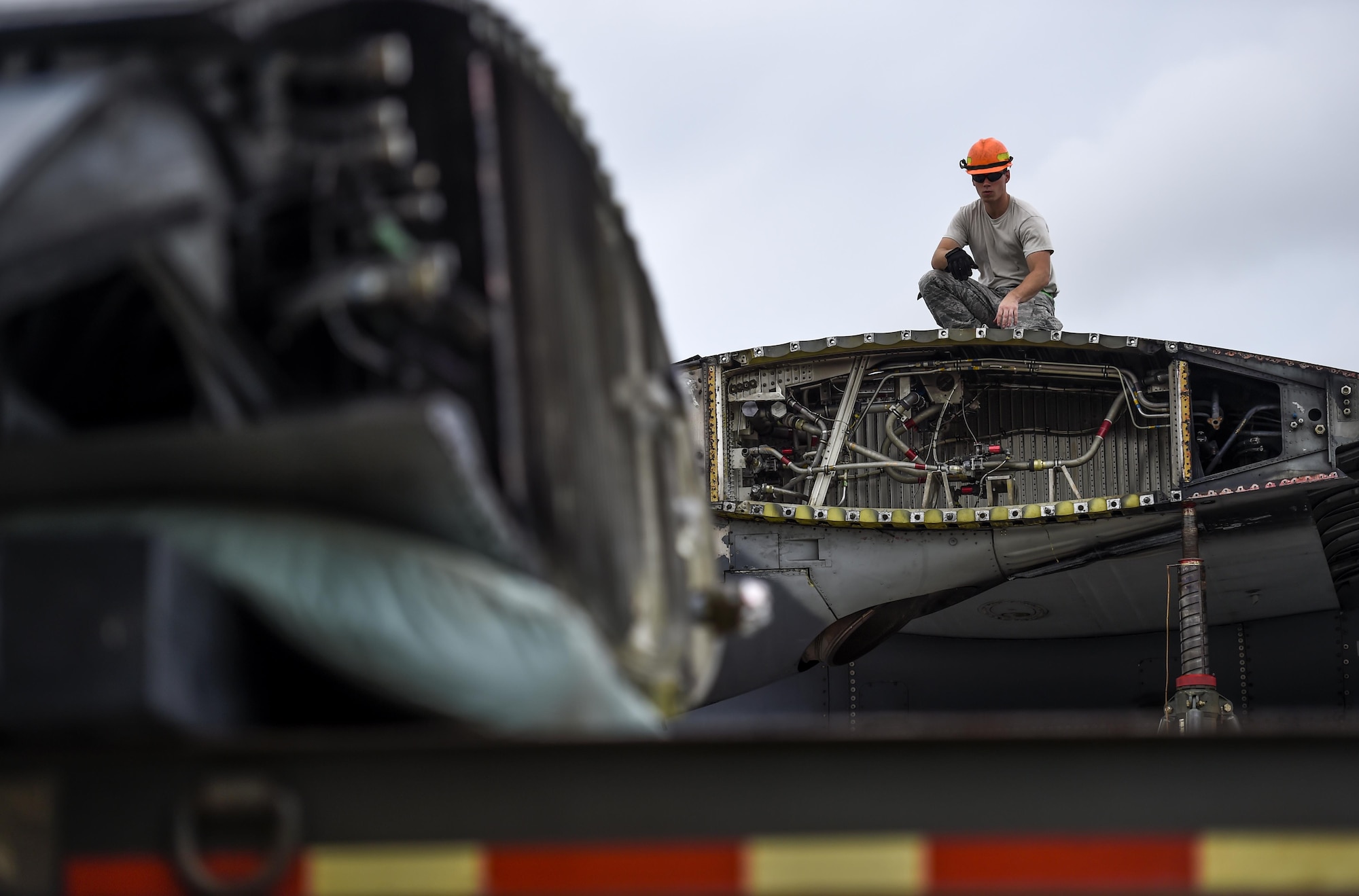 An Airman with the 402nd Expeditionary Depot Maintenance team, Robins Air Force Base, Ga., collects tools after Airmen remove a wing from an MC-130P Combat Shadow at Hurlburt Field, Fla., August 5, 2015. Wing removal enabled the MC-130P to be towed safely from the flightline to the Hurlburt Field Air Park Aug. 15, 2015.  (U.S. Air Force photo by Airman Kai White/Released)