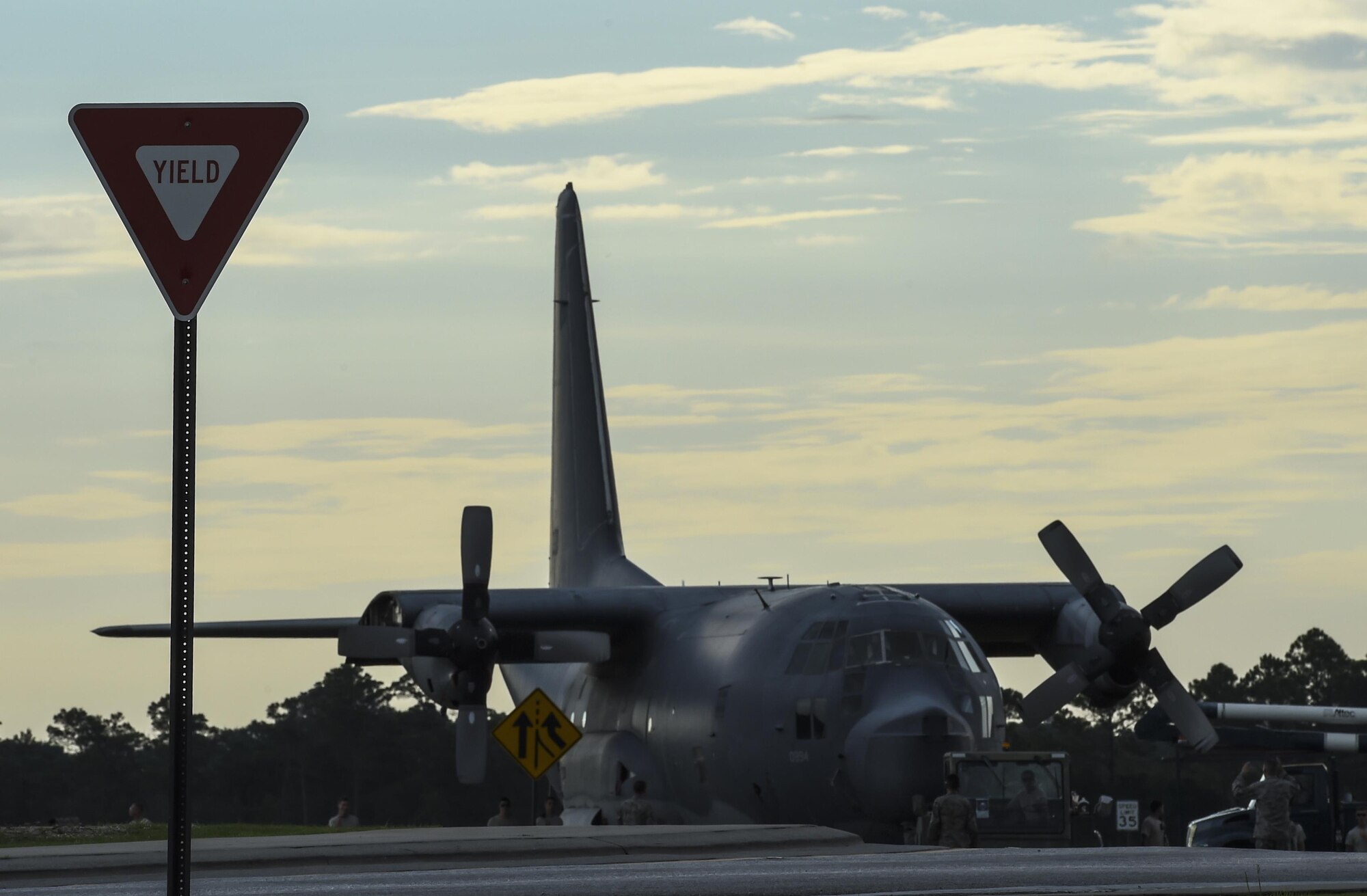 An MC-130P Combat Shadow is towed down Independence Road, Aug. 15, 2015, on Hurlburt Field, Fla. The Combat Shadow was towed from the flightline and staged for installation in the Hurlburt Field Air Park. The MC-130P fleet was retired May 15, 2015, after more than 25 years of service. The installation process for this aircraft known as “Team Shadow,” is scheduled for completion by Sept. 6, 2015. (U.S. Air Force photo by Airman 1st Class Ryan Conroy/Released)
