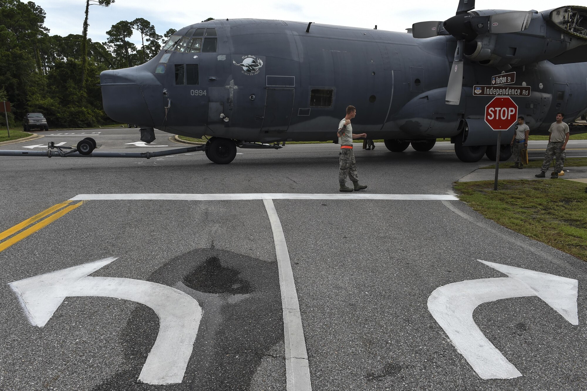 An MC-130P Combat Shadow is towed down Independence Road, Aug. 15, 2015, on Hurlburt Field, Fla. The Combat Shadow was towed from the flightline and staged for installation in the Hurlburt Field Air Park. The installation process for this aircraft known as “Team Shadow,” is scheduled for completion by Sept. 6, 2015. (U.S. Air Force photo by Airman 1st Class Ryan Conroy/Released)
