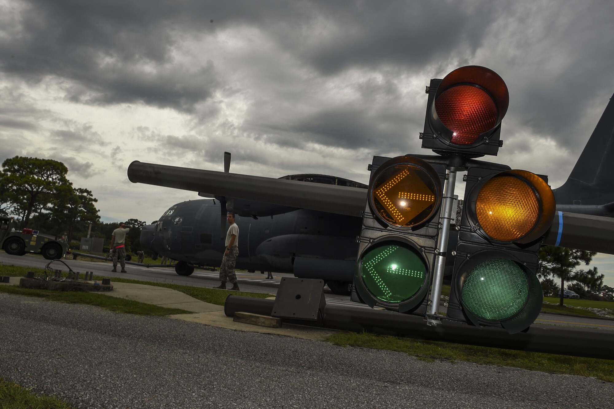 An MC-130P Combat Shadow is towed down Independence Road, Aug. 15, 2015, on Hurlburt Field, Fla. The Combat Shadow was towed from the flightline and staged for installation in the Hurlburt Field Air Park. The MC-130P fleet was retired May 15, 2015, after more than 25 years of service. The installation process for this aircraft known as “Team Shadow,” is scheduled for completion by Sept. 6, 2015. (U.S. Air Force photo by Airman 1st Class Ryan Conroy/Released)
