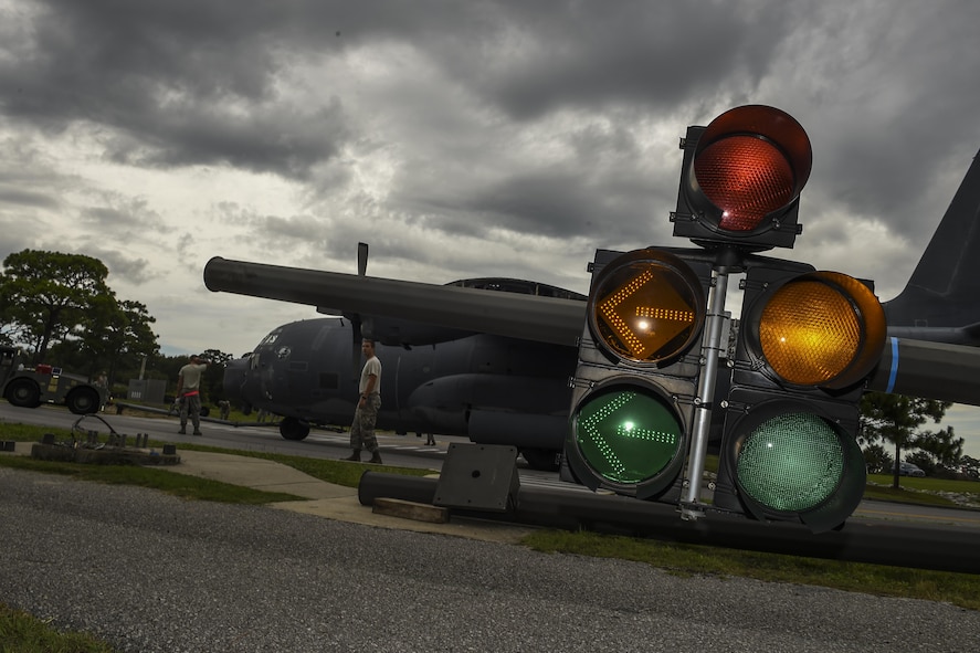 An MC-130P Combat Shadow is towed down Independence Road, Aug. 15, 2015, on Hurlburt Field, Fla. The Combat Shadow was towed from the flightline and staged for installation in the Hurlburt Field Air Park. The MC-130P fleet was retired May 15, 2015, after more than 25 years of service. The installation process for this aircraft known as “Team Shadow,” is scheduled for completion by Sept. 6, 2015. (U.S. Air Force photo by Airman 1st Class Ryan Conroy/Released)
