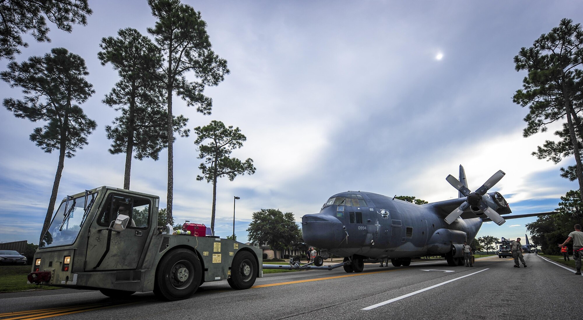 An AC-130H Spectre is towed down Independence Road on Hurlburt Field, Fla., Aug. 15, 2015. The Spectre was towed from the flightline and staged for installation into the Hurlburt Field Air Park. The AC-130H fleet retired May 26, 2015, after more than 45 years of service. The installation process for this aircraft, known as “Wicked Wanda,” is set to be complete by Aug. 28, 2015. (U.S. Air Force photo by Senior Airman Meagan Schutter/Released)