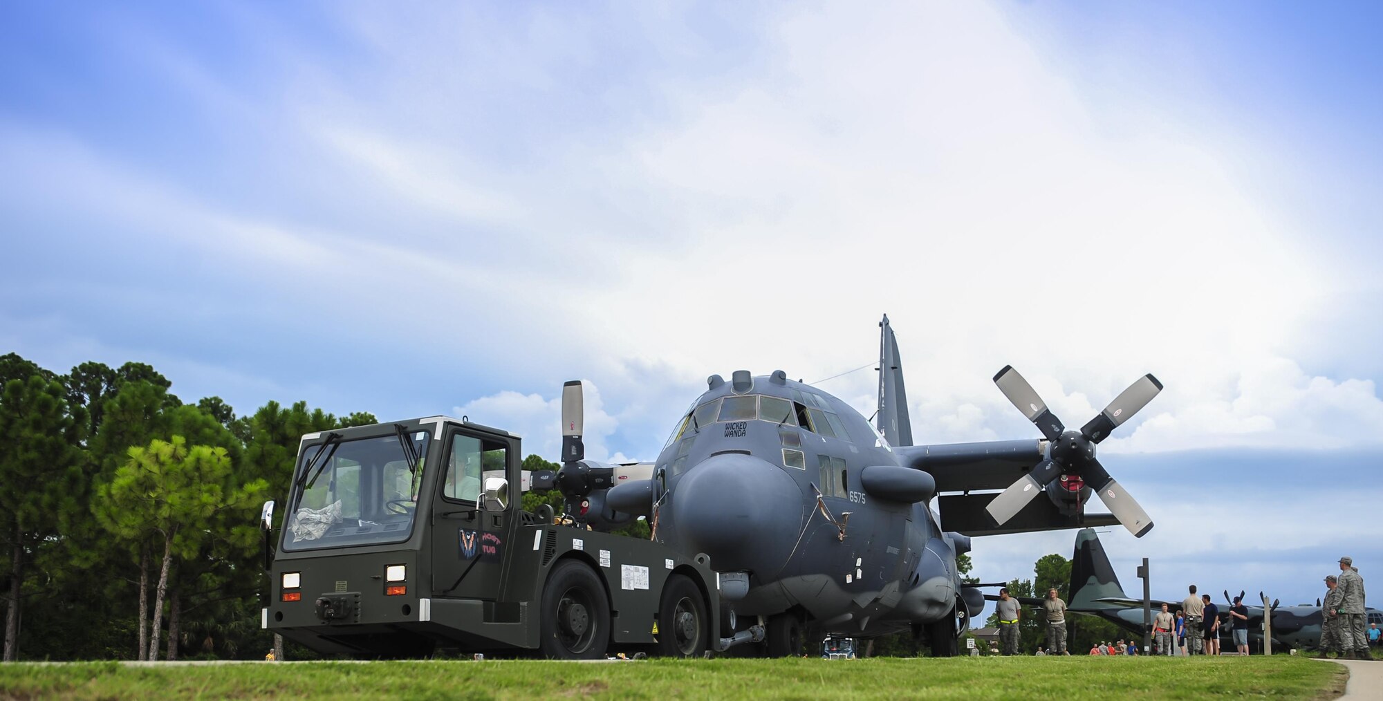 Airmen with the 1st Special Operations Aircraft Maintenance squadron tow an AC-130H Spectre down Independence Road on Hurlburt Field, Fla., Aug. 15, 2015. The Spectre was towed from the flightline and staged for installation in to the Hurlburt Field Air Park. The AC-130H fleet retired May 26, 2015, after more than 45 years of service. The installation process for this aircraft, known as “Wicked Wanda,” is set to be complete by Aug. 28, 2015. (U.S. Air Force photo by Senior Airman Meagan Schutter/Released)
