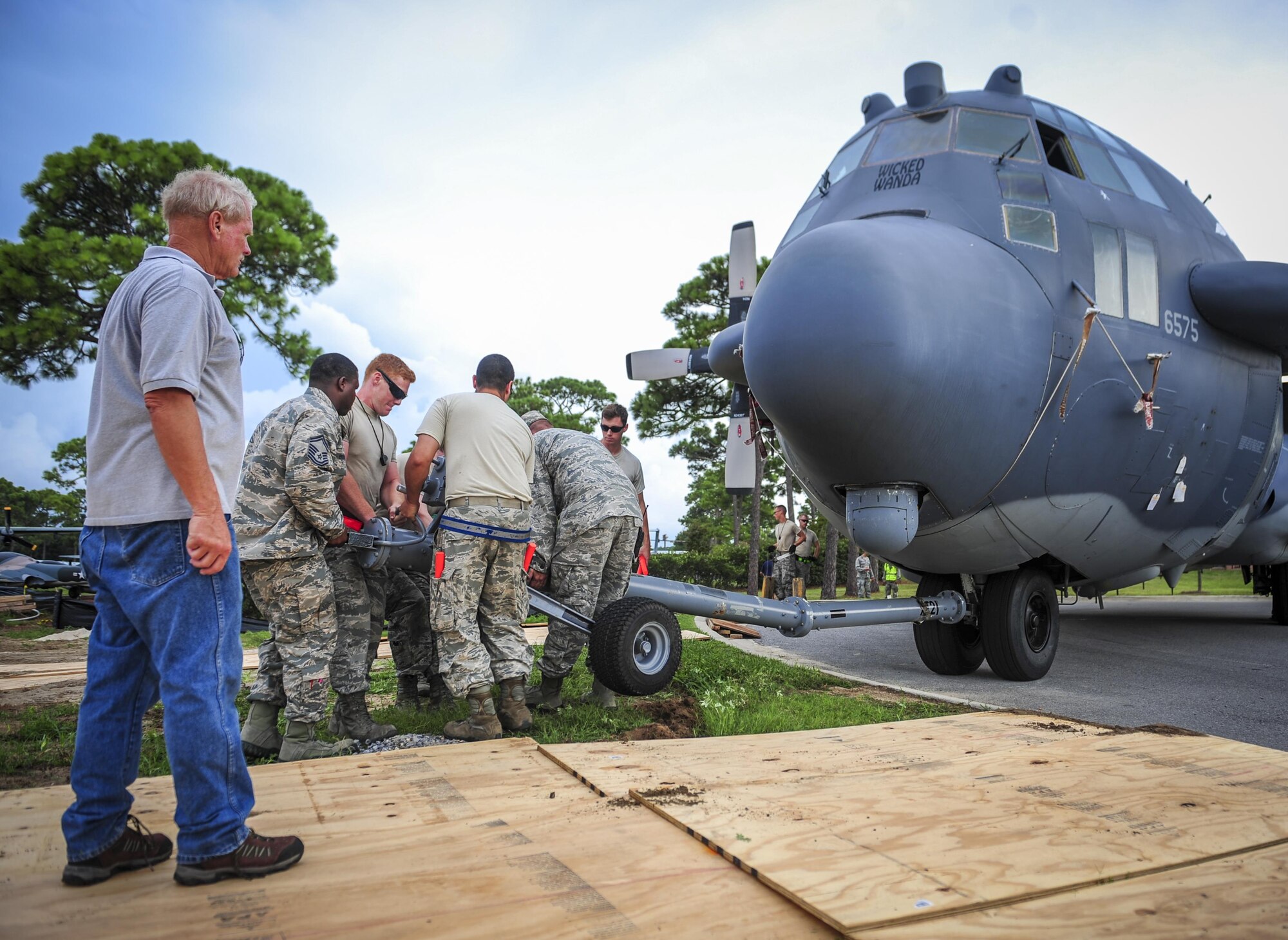 Airmen prepare to move an AC-130H Spectre into the Air Park on Hurlburt Field, Fla., Aug. 15, 2015. More than 40 personnel with eight base organizations were on site during the tow process. The AC-130H Spectre will be displayed at the North end of the Air Park. (U.S. Air Force photo by Senior Airman Meagan Schutter/Released)