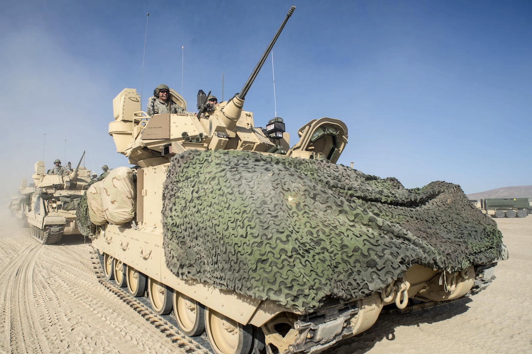 M3A3 Bradley fighting vehicles move into the training area at the National Training Center on Fort Irwin, Calif., Aug. 14, 2015. The vehicles are assigned to the Idaho Army National Guard's 2nd Squadron, 116th Cavalry Regiment, 116th Cavalry Brigade Combat Team. The soldiers moved 1,442 vehicles into the area for 12 days of live-fire exercises and force-on-force simulated battles.