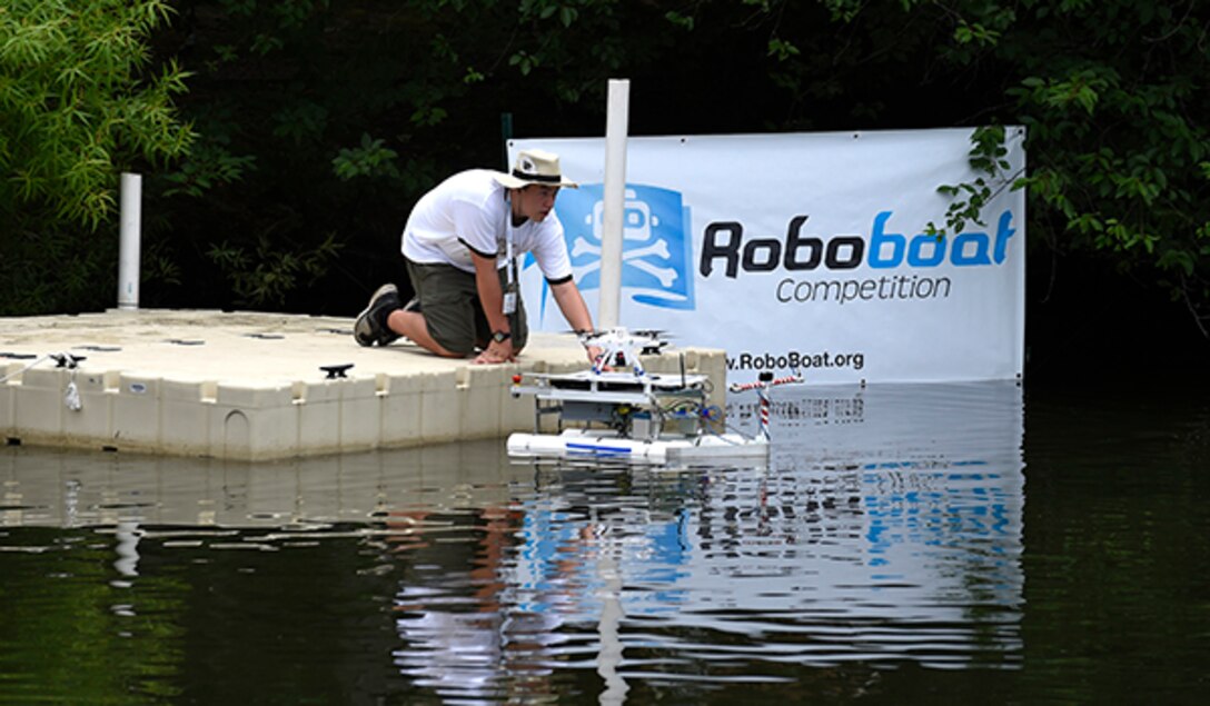 Nick Serle, 15, part of the Daytona Beach Homeschoolers team, launches their autonomous surface vehicle, named the S.S. Minnow,  during the 2015 AUVSI Foundation and Office of Naval Research-sponsored RoboBoat competition held in Virginia Beach, Va.