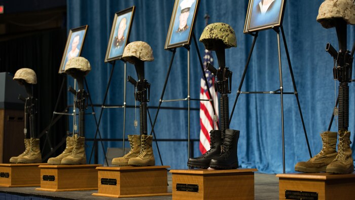 Battle crosses are mounted on stage at the Mckenzie Arena at the University of Tennessee at Chattanooga, Aug. 15, 2015. The battle crosses are symbolic replacements for crosses for service members who have fallen in the line of duty. Four Marines and one sailor died during a shooting in Chattanooga, Tennessee, July 16, 2015. 