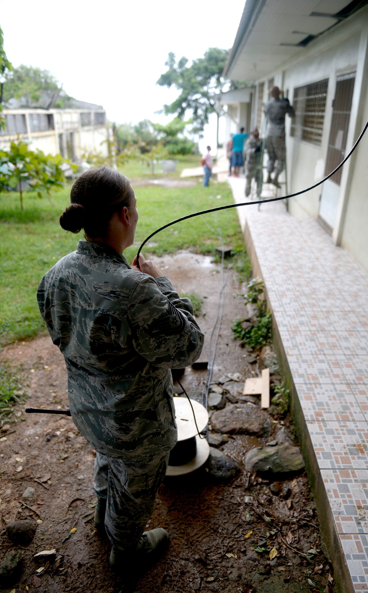 U.S. Air Force Tech Sgt. Jasmine Matus, radio frequency transmissions craftsman, provides category six cable to U.S. Air Force Tech Sgt. Carl Koenig, radio frequency transmissions technician (right) who is installing it in the roof of the Dr. Salvador Paredes Hospital in Trujillo, Honduras, June 29, 2015, with the help of U.S. Air Force Senior Airman Trenton Freeman, client systems journeyman (center). The combat communications Airmen are with the 35th Combat Communications Squadron out of Tinker Air Force Base, Okla., and were in the hospital to repair its ailing network as part of the New Horizons Honduras 2015 training exercise. 

New Horizons was launched in the 1980s and is an annual joint humanitarian assistance exercise that U.S. Southern Command conducts with a partner nation in Central America, South America or the Caribbean. The exercise improves joint training readiness of U.S. and partner nation civil engineers, medical professionals and support personnel through humanitarian assistance activities. (U.S. Air Force photo by Capt. David J. Murphy/Released)