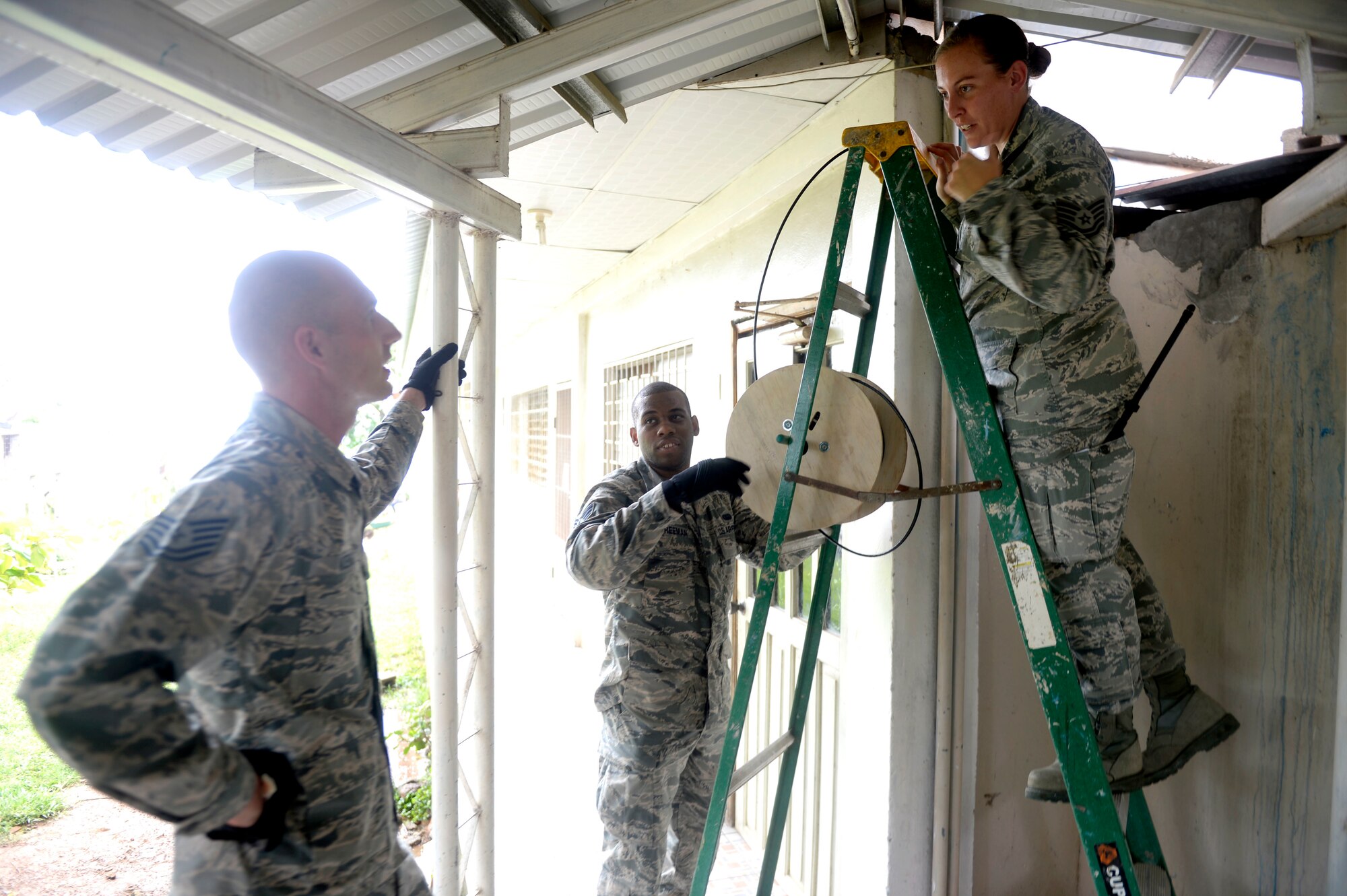 U.S. Air Force Tech Sgt. Carl Koenig, radio frequency transmissions technician, U.S. Air Force Senior Airman Trenton Freeman, client systems journeyman, and U.S. Air Force Tech Sgt. Jasmine Matus, all of the 35th Combat Communications Squadron out of Tinker Air Force Base, Okla., discuss their plan to wire the Dr. Salvador Paredes Hospital in Trujillo, Honduras, June 29, 2015, with category six cable in order to restore internet connectivity to nine offices. The combat communications Airmen were in the hospital to repair its ailing network and restore Internet connectivity as part of the New Horizons Honduras 2015 training exercise. 

New Horizons was launched in the 1980s and is an annual joint humanitarian assistance exercise that U.S. Southern Command conducts with a partner nation in Central America, South America or the Caribbean. The exercise improves joint training readiness of U.S. and partner nation civil engineers, medical professionals and support personnel through humanitarian assistance activities. (U.S. Air Force photo by Capt. David J. Murphy/Released)