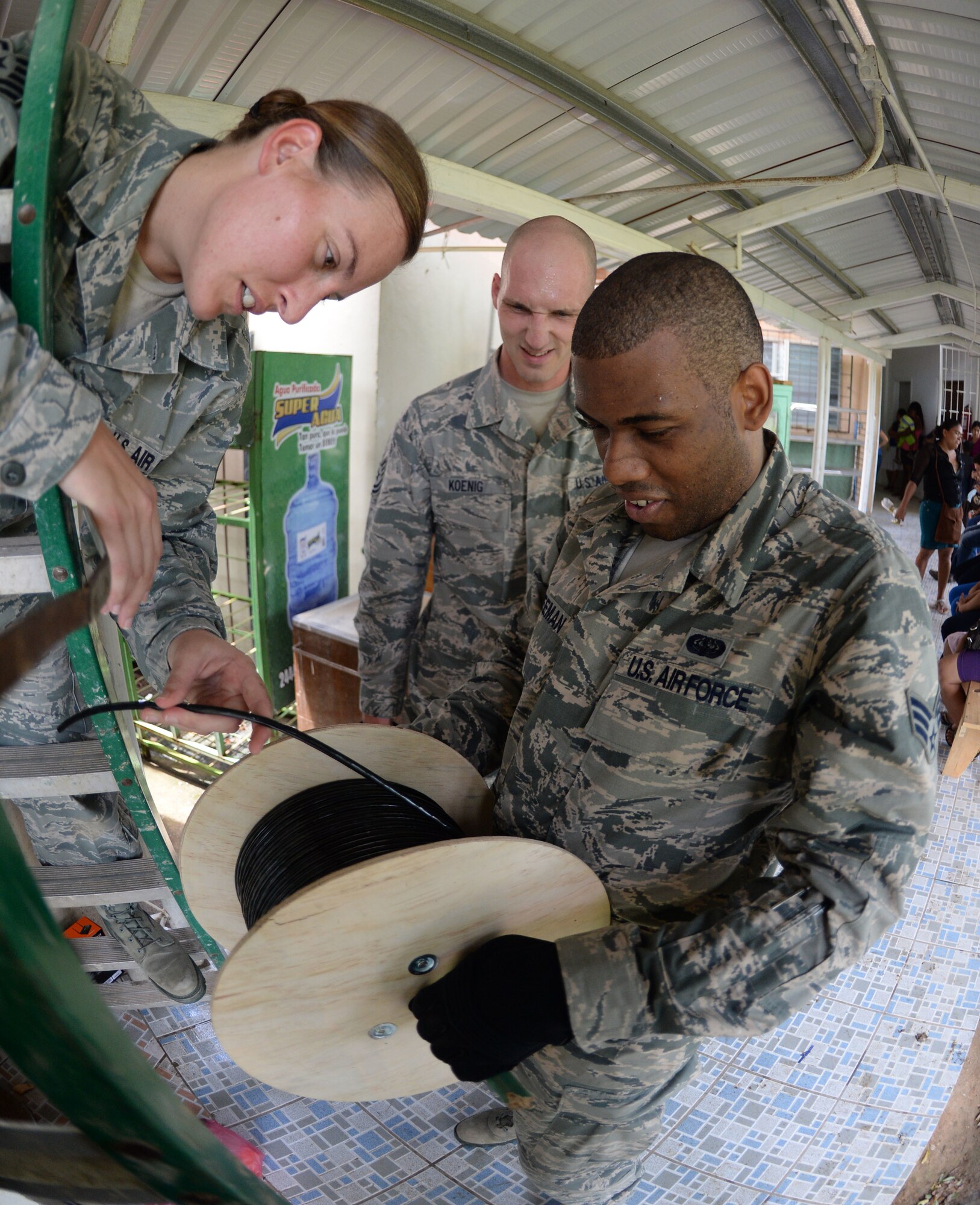 U.S. Air Force Tech Sgt. Carl Koenig, radio frequency transmissions technician (center), U.S. Air Force Senior Airman Trenton Freeman, client systems journeyman (right), and U.S. Air Force Tech Sgt. Jasmine Matus, radio frequency transmissions craftsman (left), all of the 35th Combat Communications Squadron out of Tinker Air Force Base, Okla., work through their plan to wire the Dr. Salvador Paredes Hospital in Trujillo, Honduras, June 29, 2015, with category six cable in order to restore internet connectivity to nine offices. The combat communications Airmen were in the hospital to repair its ailing network and restore Internet connectivity as part of the New Horizons Honduras 2015 training exercise. 

New Horizons was launched in the 1980s and is an annual joint humanitarian assistance exercise that U.S. Southern Command conducts with a partner nation in Central America, South America or the Caribbean. The exercise improves joint training readiness of U.S. and partner nation civil engineers, medical professionals and support personnel through humanitarian assistance activities. (U.S. Air Force photo by Capt. David J. Murphy/Released)