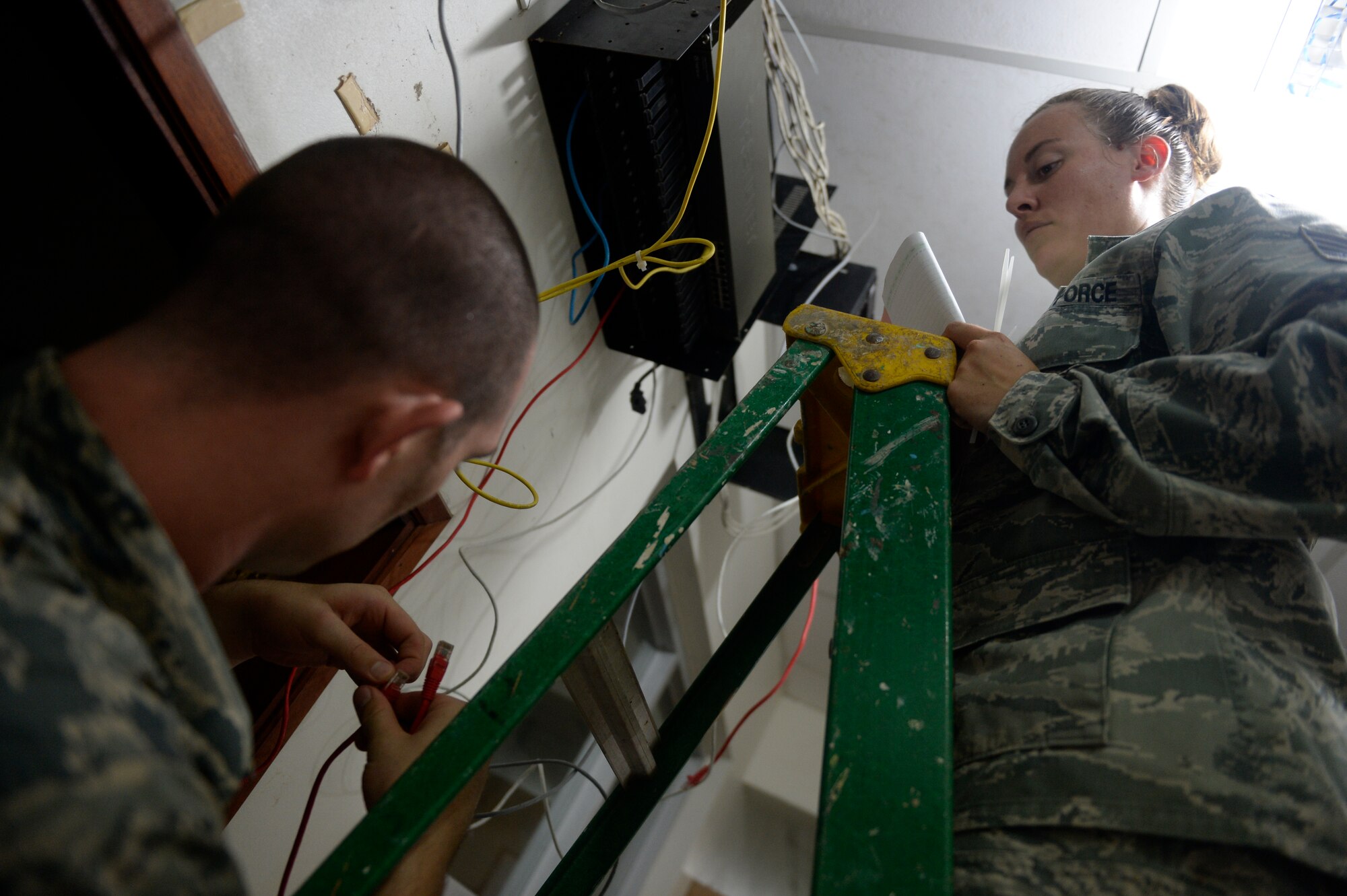 U.S. Air Force Senior Airman Christopher Harkins radio frequency transmissions craftsman assists U.S. Air Force Tech Sgt. Jasmine Matus, radio frequency transmissions craftsman, both of the 35th Combat Communications Squadron as she reconfigures the router for the Dr. Salvador Paredes Hospital in Trujillo, Honduras, July 9, 2015, Matus and Harkins were in the hospital to repair its ailing network infrastructure as part of the New Horizons Honduras 2015 training exercise. 

New Horizons was launched in the 1980s and is an annual joint humanitarian assistance exercise that U.S. Southern Command conducts with a partner nation in Central America, South America or the Caribbean. The exercise improves joint training readiness of U.S. and partner nation civil engineers, medical professionals and support personnel through humanitarian assistance activities.

(U.S. Air Force photo by Capt. David J. Murphy/Released)