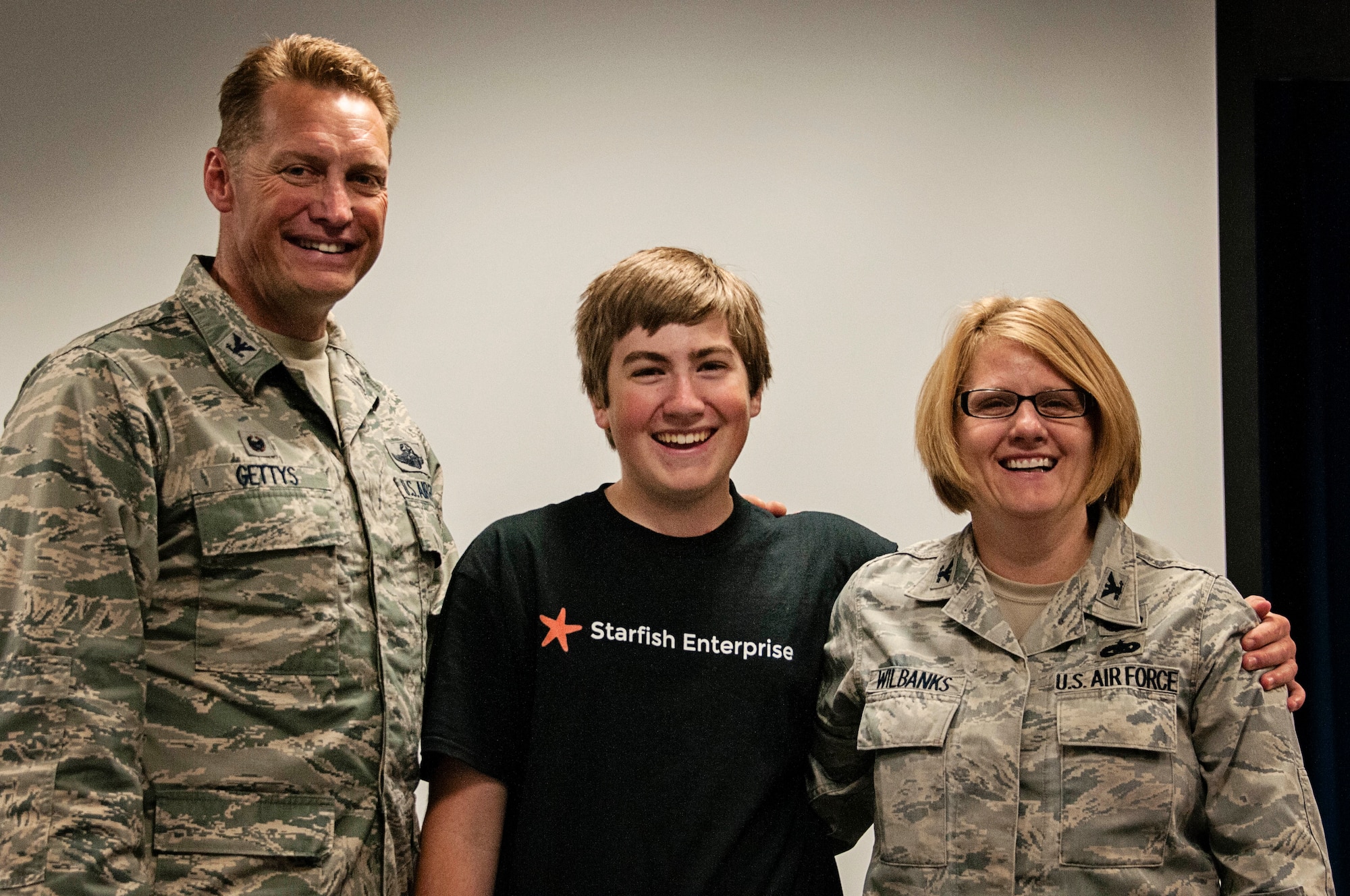 Col. Blake Gettys, commander of the 176th Wing, Alaska Air National Guard, poses for a photo with Brice Wilbanks and his mother, Col. Patty Wilbanks, commander of the 176th Mission Support Group, after being presented with a letter of thanks from Lt. Gen. Stanley Clarke III, director of the Air National Guard, at a ceremony on Joint Base Elmendorf-Richardson, Alaska, Aug. 14. Brice was presented the letter in recognition of being the recipient of the 2015 Air National Guard Youth of the Year award. (U.S. Air National Guard photo by Staff Sgt. Edward Eagerton/released)