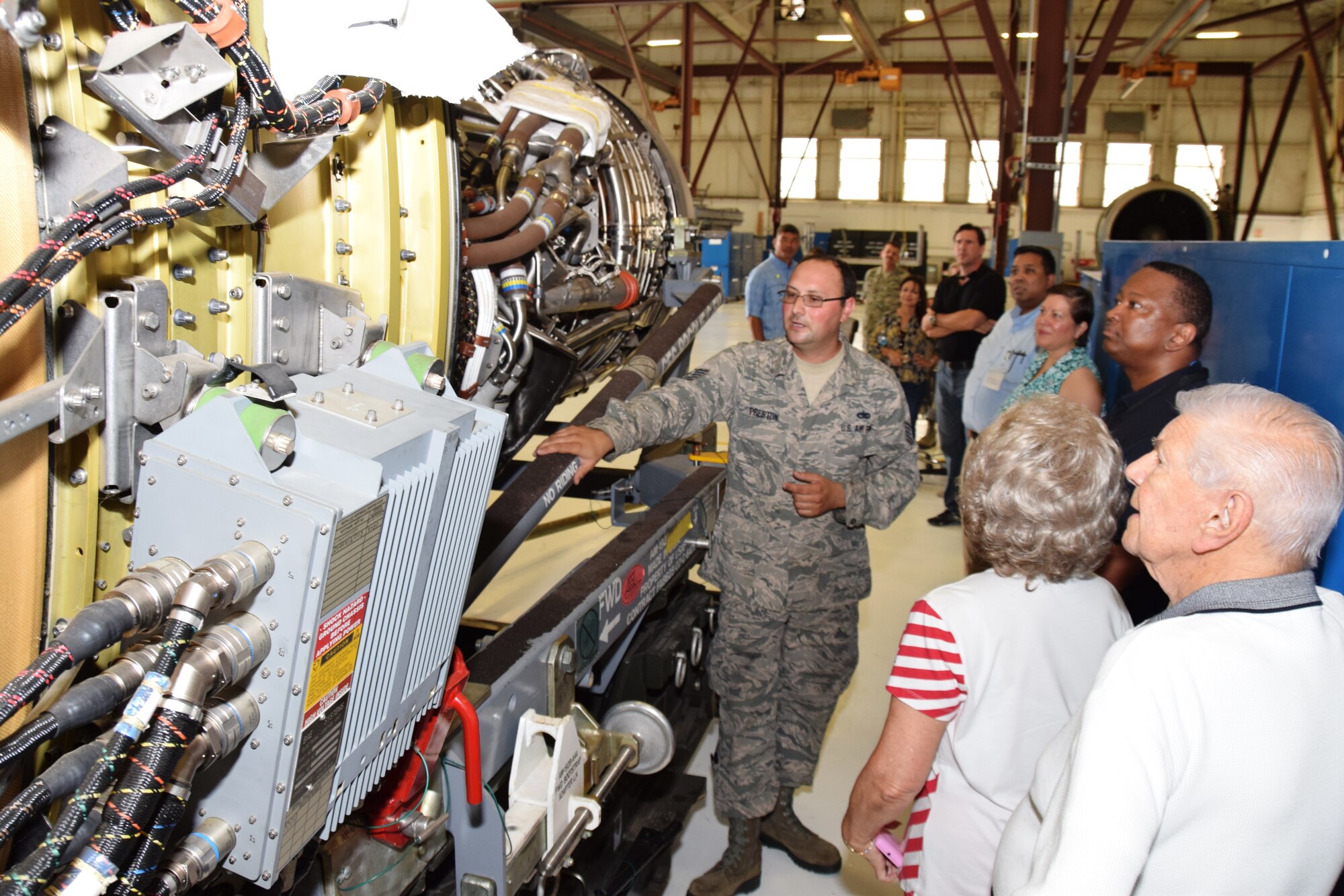 Tech. Sgt. Sean Preston, a maintenance technician with the 433rd Maintenance Group, describes the functions of the C-5A Galaxy’s TF-39 turbofan engine to the 433rd Airlift Wing honorary commanders on Aug. 15, 2015 at Joint Base San Antonio-Lackland, Texas.  Preston then showed the group a new engine that will be used on the C-5M Super Galaxy, which the Alamo Wing will begin acquiring next year. (U.S. Air Force photo by Tech. Sgt. Carlos J. Trevino)