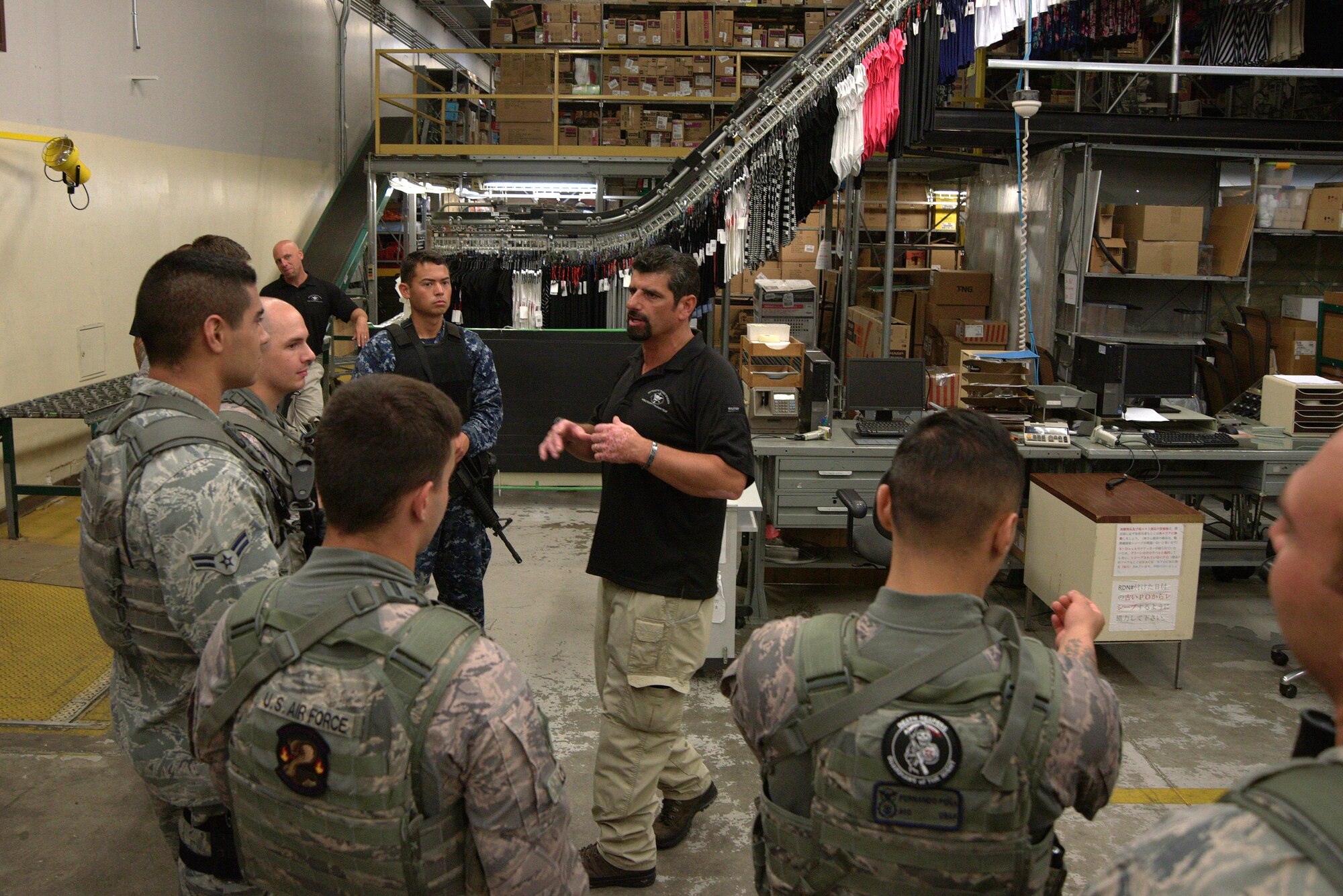 John Knipe, Pacific Air Forces High Risk Response Training instructor, guides security personnel on tactics for safely securing areas during an active-shooter threat exercise at Misawa Air Base, Japan, Aug. 14, 2015. Security personnel took part in a five-day training course where they learned about tactics and techniques based on contemporary special weapons and tactics training. (U.S. Air Force photo by Senior Airman Jose L. Hernandez-Domitilo/Released)