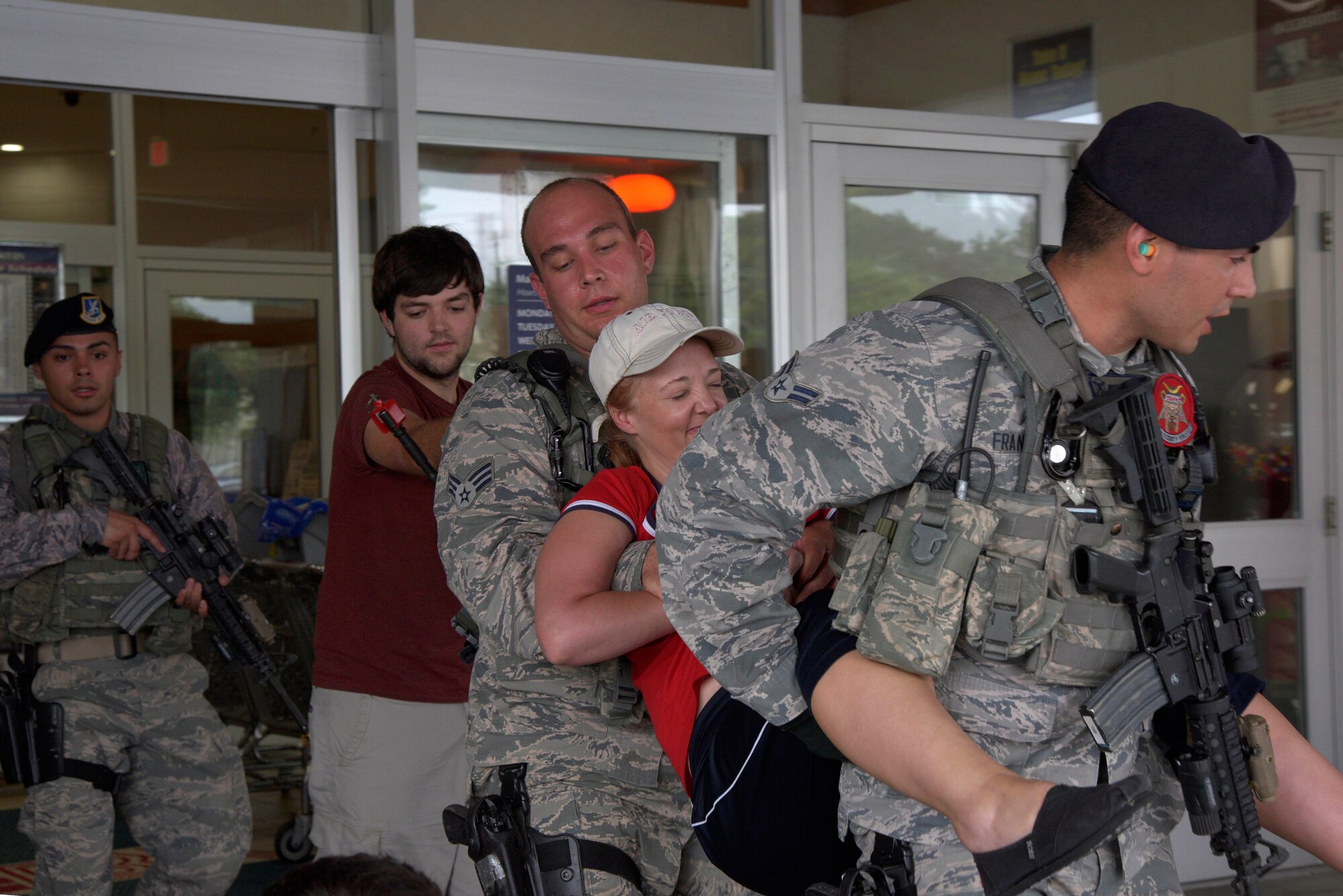 Response Force Members from the 35th Security Forces Squadron carry a mock injured victim to safety as part of an active-shooter threat exercise at Misawa Air Base, Japan, Aug. 14, 2015. Mock victims are moved to safety and provided first aid once additional security forces personnel arrive to assist in neutralizing the threat. (U.S. Air Force photo by Senior Airman Jose L. Hernandez-Domitilo/Released)