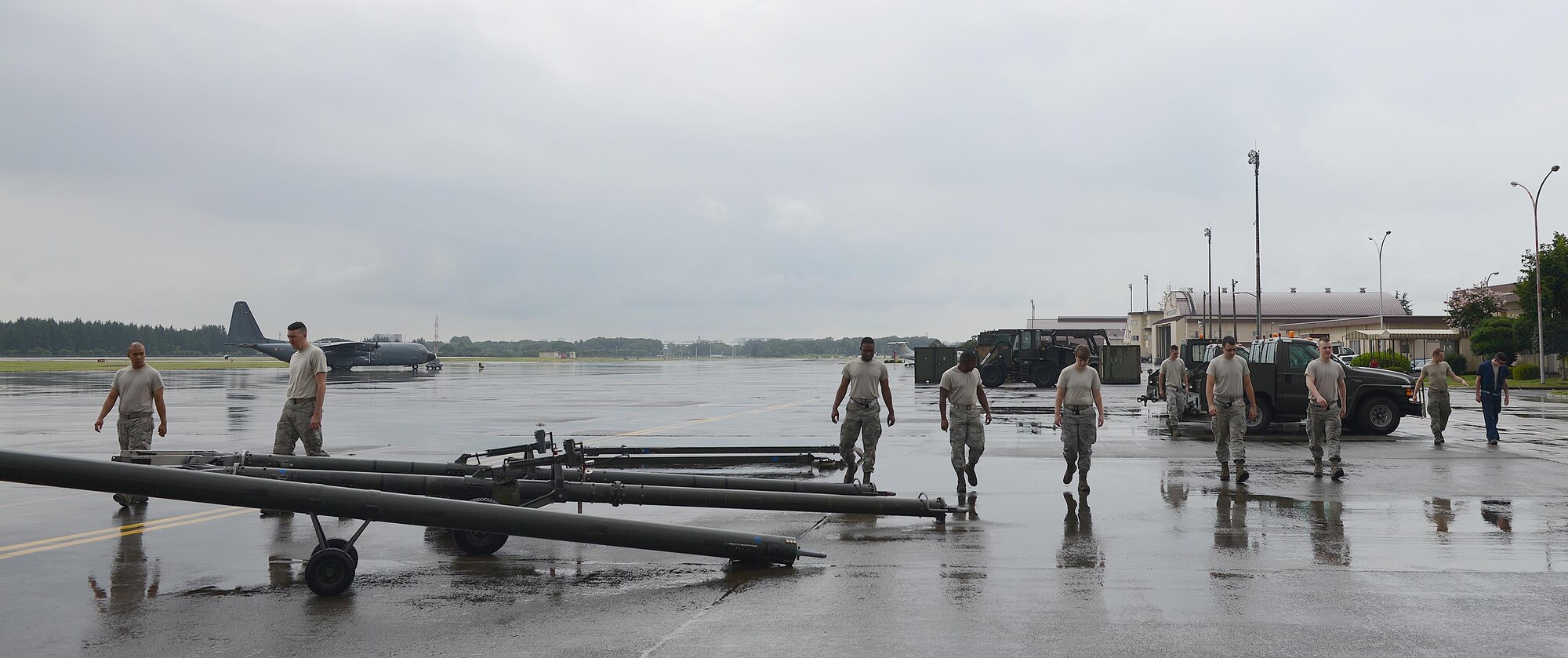 U.S. Air Force Airmen from the 374th Maintenance Squadron conduct a foreign object debris search at Yokota Air Base, Japan, Aug. 12, 2015. FOD walks are performed daily to ensure the safety of Yokota’s Airmen and equipment. (U.S. Air Force photo by Senior Airman David C. Danford/Released)