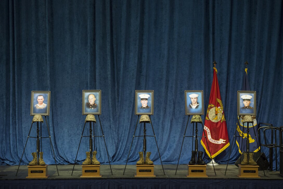 Portrait of Gunnery Sgt. Thomas Sullivan, left, Staff Sgt. David Wyatt, Sgt. Carson Holmquist, Petty Officer 2nd Class Randall Smith, and Lance Cpl. Squire Wells sit on the stage of a memorial service in their honor in Chattanooga, Tenn, Aug. 15, 2015. The five service members were killed on July 16, 2016. 