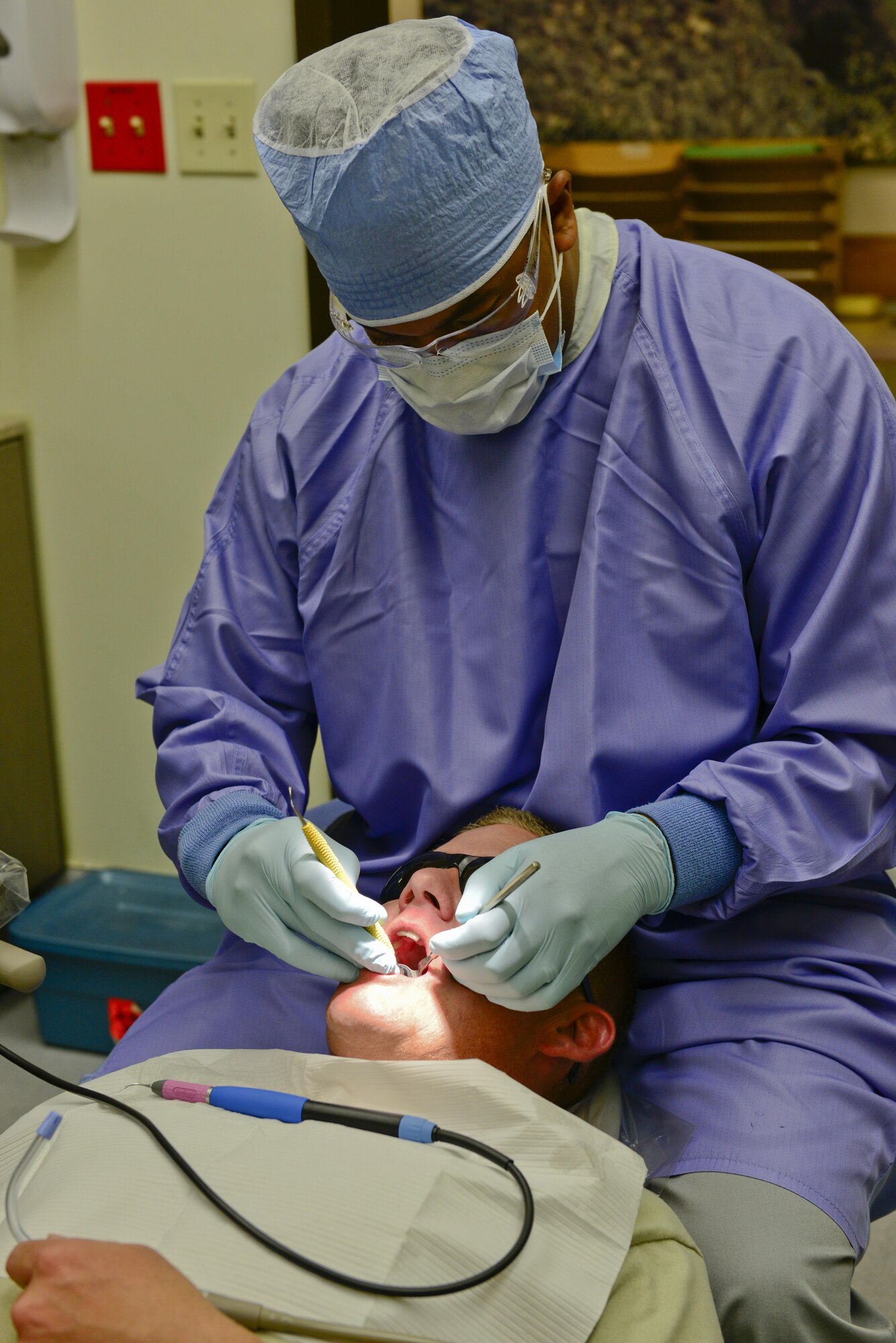 U.S. Air Force Tech. Sgt. Robert Penn, 51st Dental Squadron technician, cleans the teeth of Tech. Sgt. William Spraggins, 51st Civil Engineer Squadron Airman dorm leader on Osan Air Base, Republic of Korea, Aug. 7, 2015. Ensuring Airmen here were “fit-to-fight,” the 51st Dental Squadron was recognized for having the number one readiness rating in the Air Force at 99.7 percent. (U.S. Air Force photo by Senior Airman Kristin High/Released)