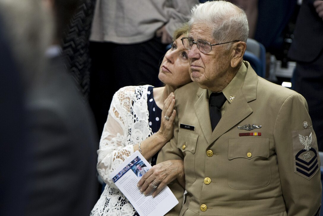 Two memorial goers watch as Secretary Carter speaks during a ceremony held in memory of the sailor and four Marines killed in Chattanooga on July 16, Chattanooga, Tenn.,  Aug. 15, 2015.