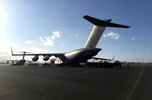 U.S. Air Force Airmen prepare to load logistics equipment aboard a U.S. Air Force 535th Airlift Squadron C-17 Globemaster III bound for Saipan, Aug. 8, 2015, Joint Base Pearl Harbor-Hickam, Hawaii. Pacific Airmen are working alongside their joint and civilian counterparts to support Saipan relief efforts in the aftermath of Typhoon Soudelor. (U.S. Air Force courtesy photo/Released)