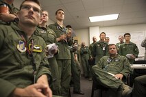 Members of the U.S. Air Force, Japan Air Self-Defense Force, Royal Australian Air Force and executive observers attend a mission briefing during Red Flag-Alaska at Joint Base Elmendorf-Richardson, Alaska, Aug. 10, 2015. Red Flag-Alaska is an exercise that provides joint offensive counter-air, interdiction, close air support and large force employment training in a simulated combat environment. More than 20 allied countries have participated in Red Flag-Alaska since its conception, improving integration, interoperability and cross-cultural competence. (U.S. Air Force photo by Staff Sgt. Cody H. Ramirez/Released)