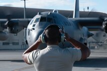 A U.S. Air Force maintainer with the 374th Aircraft Maintenance Squadron marshals a C-130 Hercules from Yokota Air Base, Japan, during Red Flag-Alaska at Joint Base Elmendorf-Richardson, Alaska, Aug. 11, 2015. Red Flag-Alaska is an exercise that provides joint offensive counter-air, interdiction, close air support and large force employment training in a simulated combat environment. More than 20 allied countries have participated in Red Flag-Alaska since its conception, improving integration, interoperability and cross-cultural competence. (U.S. Air Force photo by Staff Sgt. Cody H. Ramirez/Released)