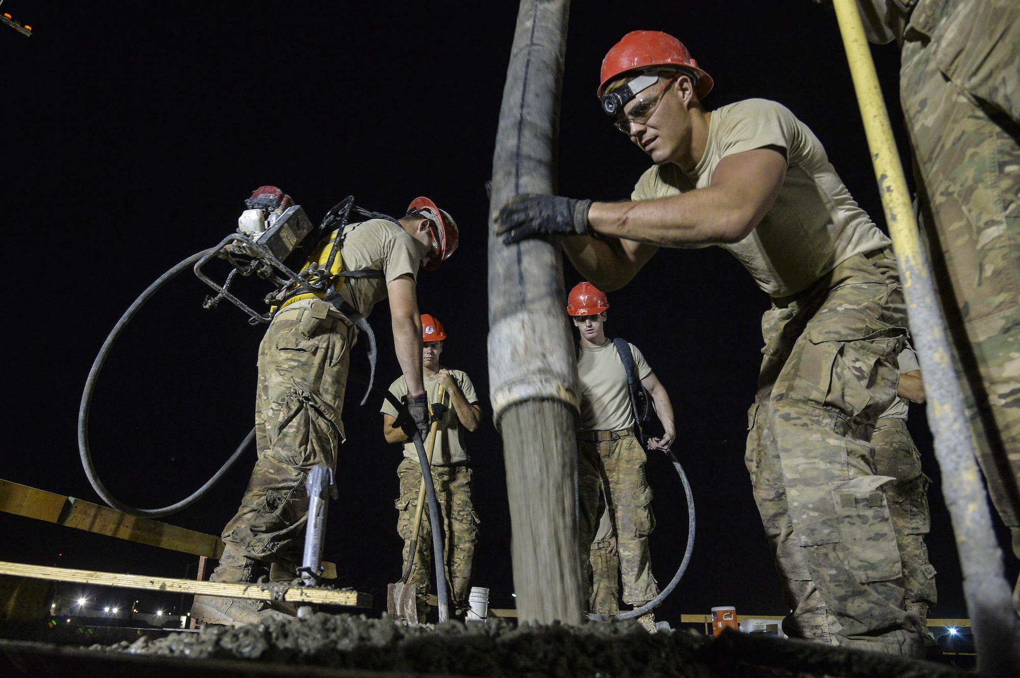 Senior Airman Anthony pours a concrete roof on a structure at an undisclosed location in Southwest Asia July 28, 2015. Airman Anthony is a structural apprentice assigned to the 557th Expeditionary RED HORSE Squadron. (U.S. Air Force photo/Tech. Sgt. Christopher Boitz)