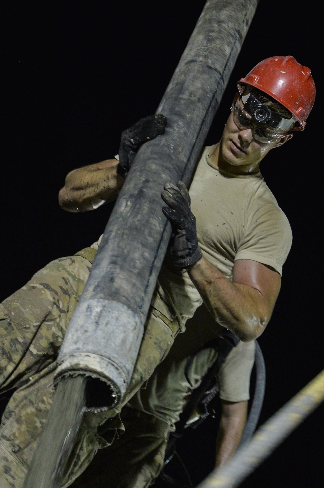 Senior Airman Anthony pours a concrete roof on a structure at an undisclosed location in Southwest Asia July 28, 2015. Airman Anthony is a structural apprentice assigned to the 557th Expeditionary RED HORSE Squadron. (U.S. Air Force photo/Tech. Sgt. Christopher Boitz)