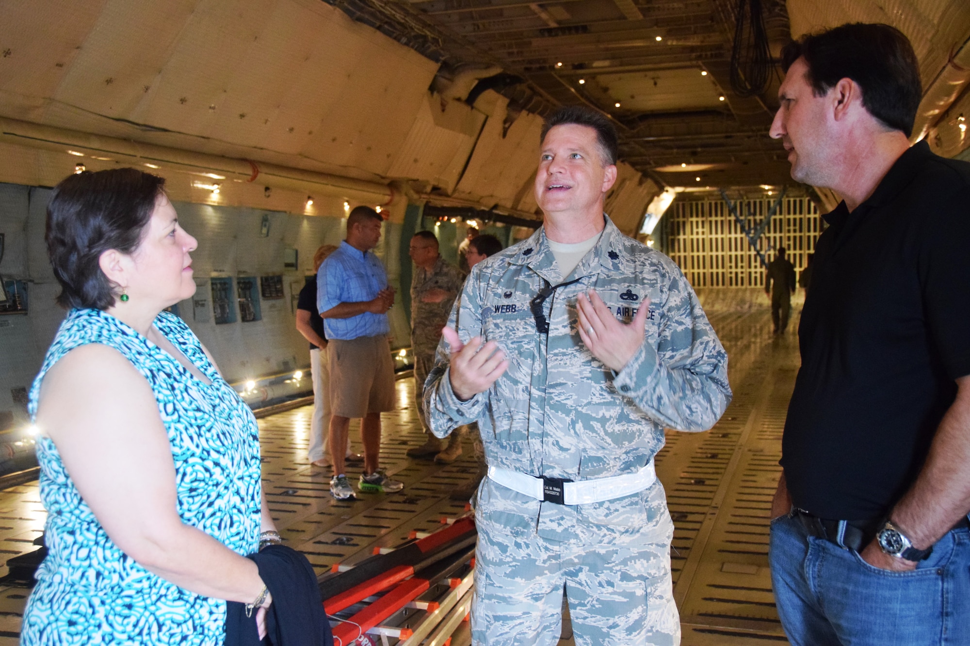 Lt. Col. Michael Webb, 433rd Aircraft Maintenance Squadron commander, talks about his squadron’s mission to Linda Cubero (left), honorary commander for the 433rd Aeromedical Staging Squadron and Travis Pearson, honorary commander for the 733rd Training Squadron while on a tour of a C-5A Galaxy on Aug. 15, 2015 at Joint Base San Antonio-Lackland, Texas.  The honorary commanders toured the troop compartment, the flight and  cargo decks. (U.S. Air Force photo by Tech. Sgt. Carlos J. Trevino)