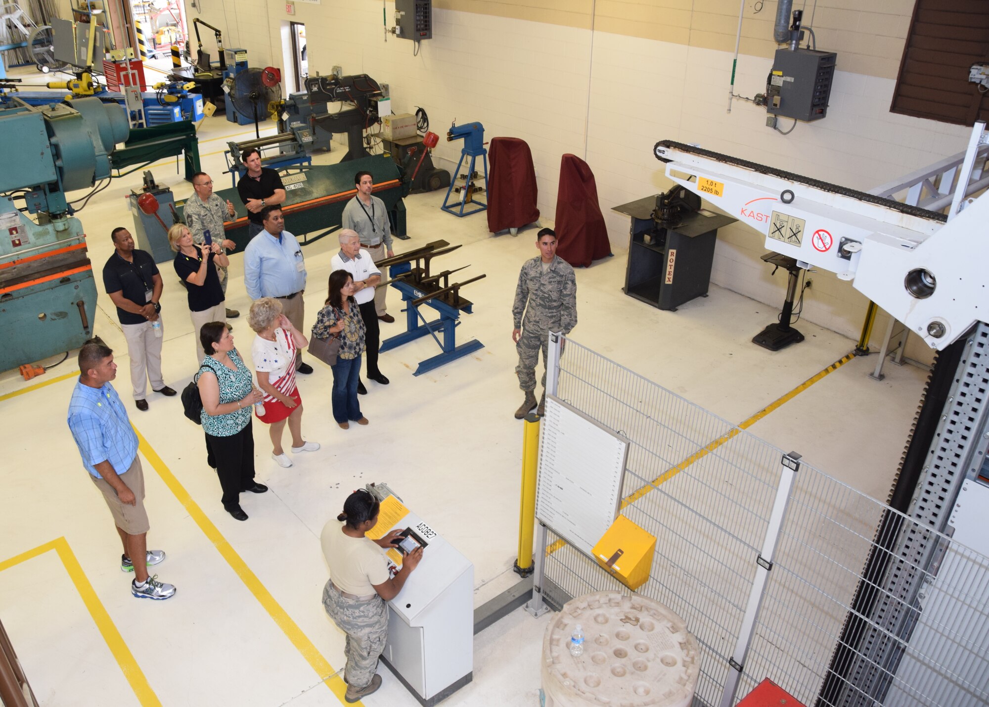Senior Airman Ivan Vela, a 433rd Maintenance Squadron structural repair technician, describes the how tools can be ordered and stored using their automated storage system to the 433rd Airlift Wing honorary commanders on Aug. 15, 2015 at Joint Base San Antonio-Lackland, Texas.  Vela described how tools are ordered on a computer and the machine finds the right tool then delivers it to the requester. (U.S. Air Force photo by Tech. Sgt. Carlos J. Trevino)